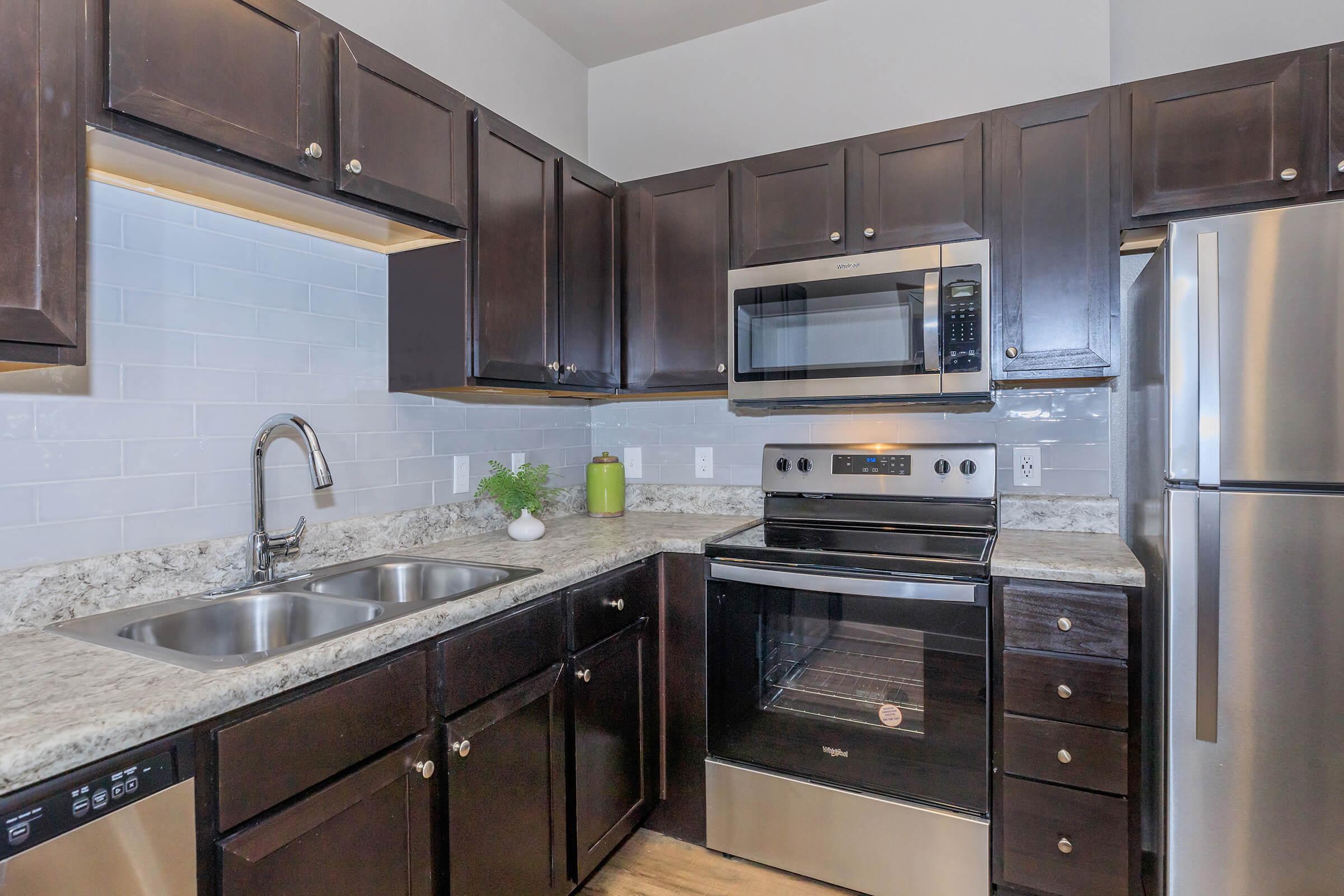 a large kitchen with stainless steel appliances