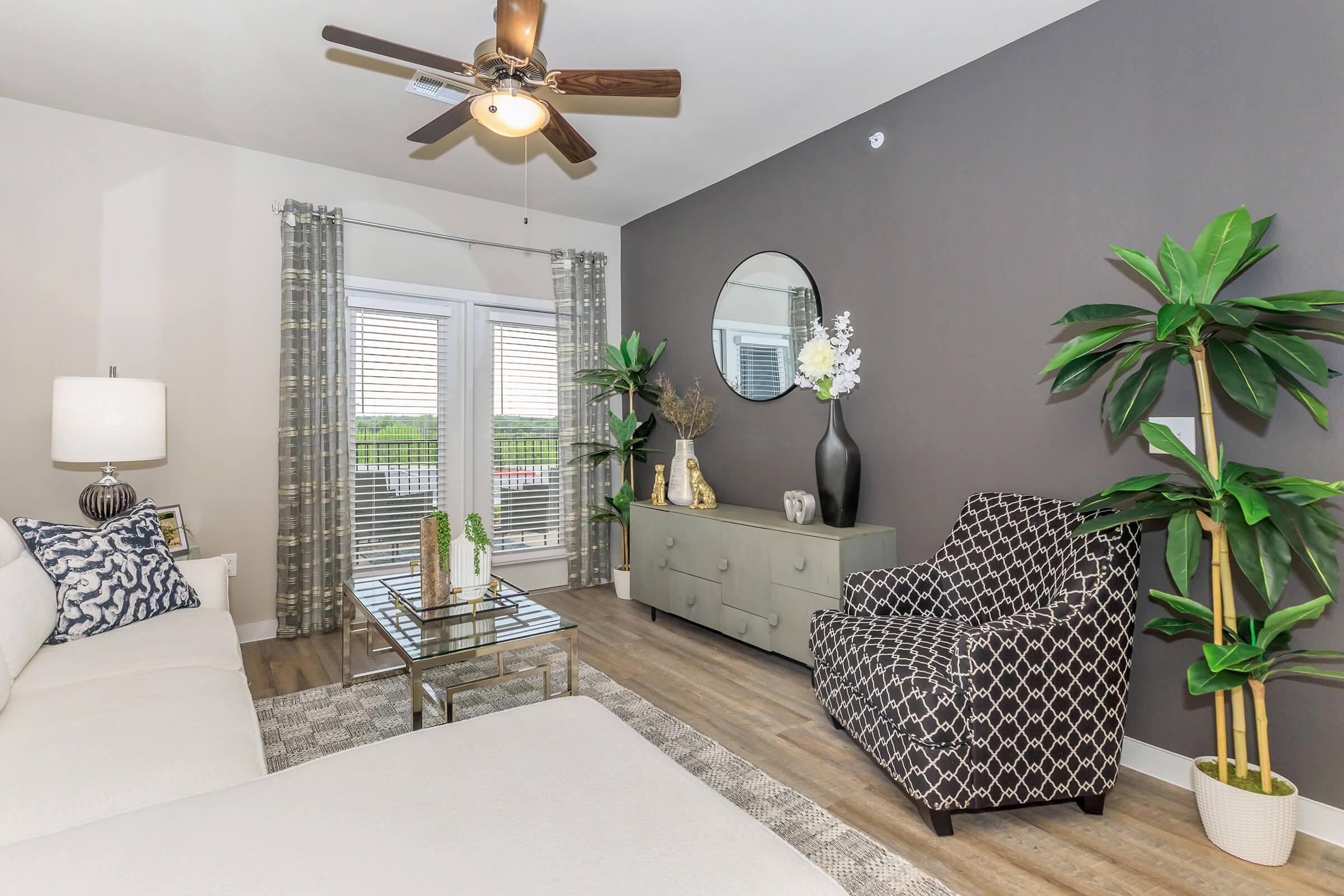 a living room filled with furniture and a large window