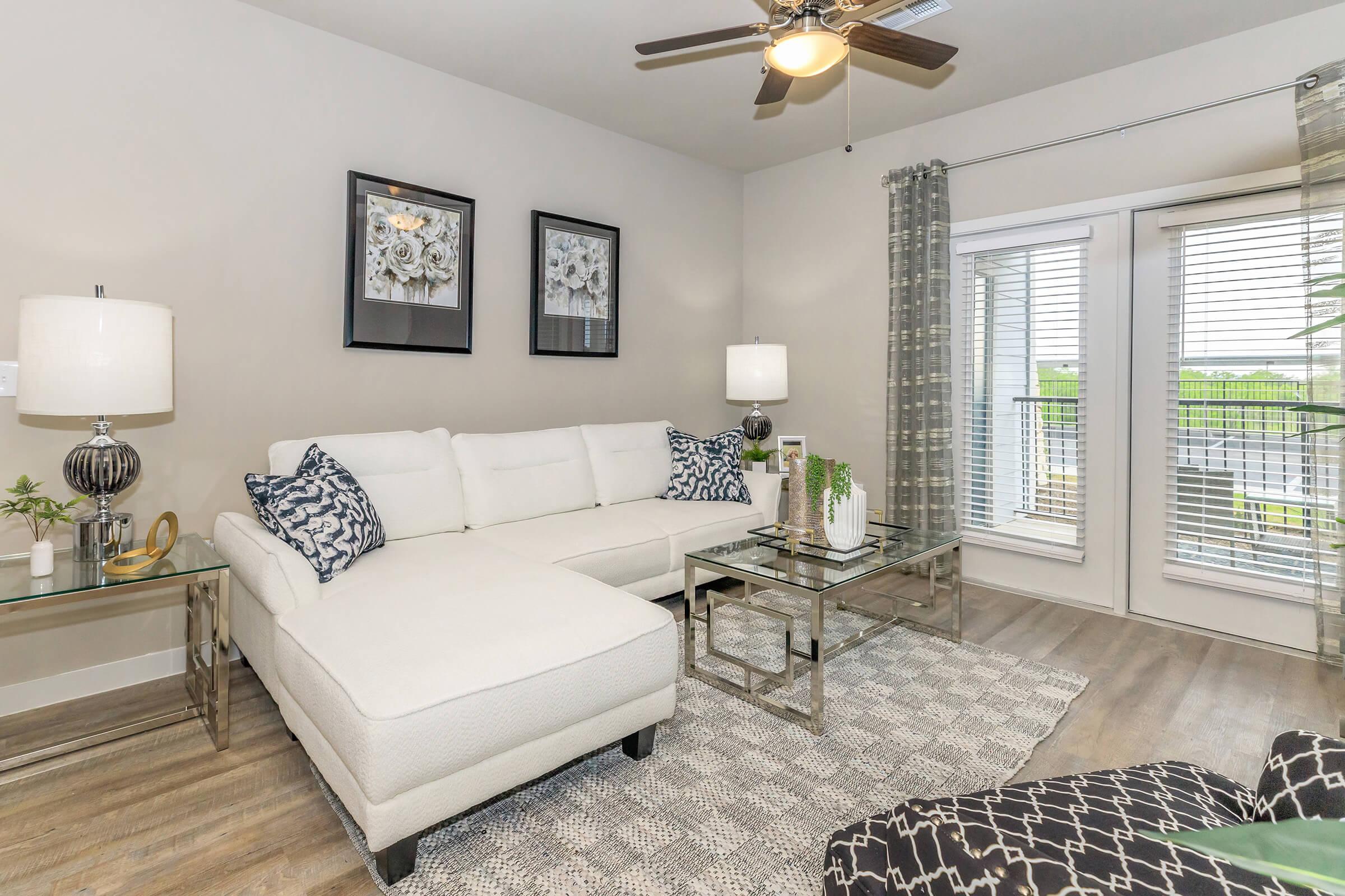 a living room filled with furniture and a large window