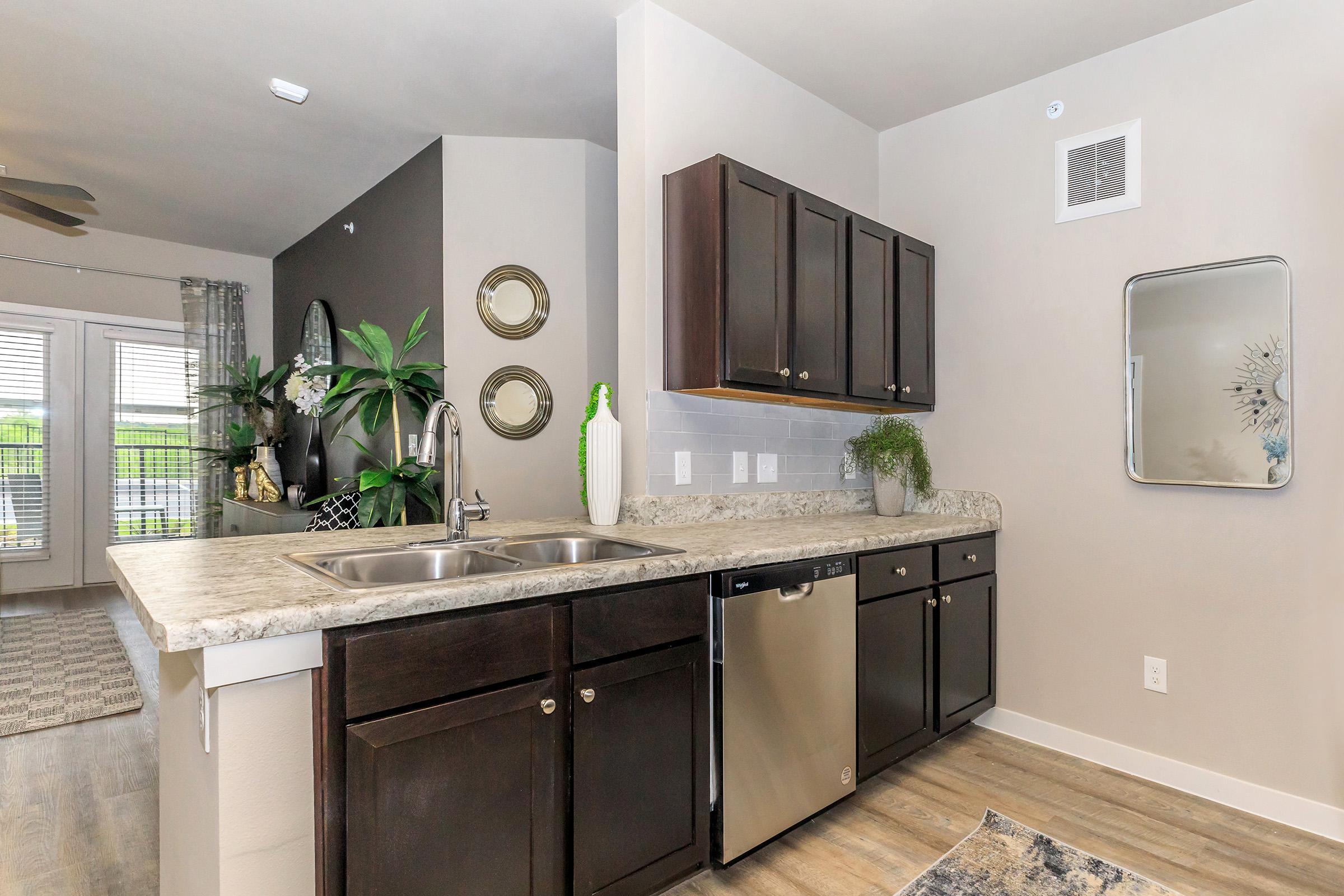 a kitchen with a sink and a mirror