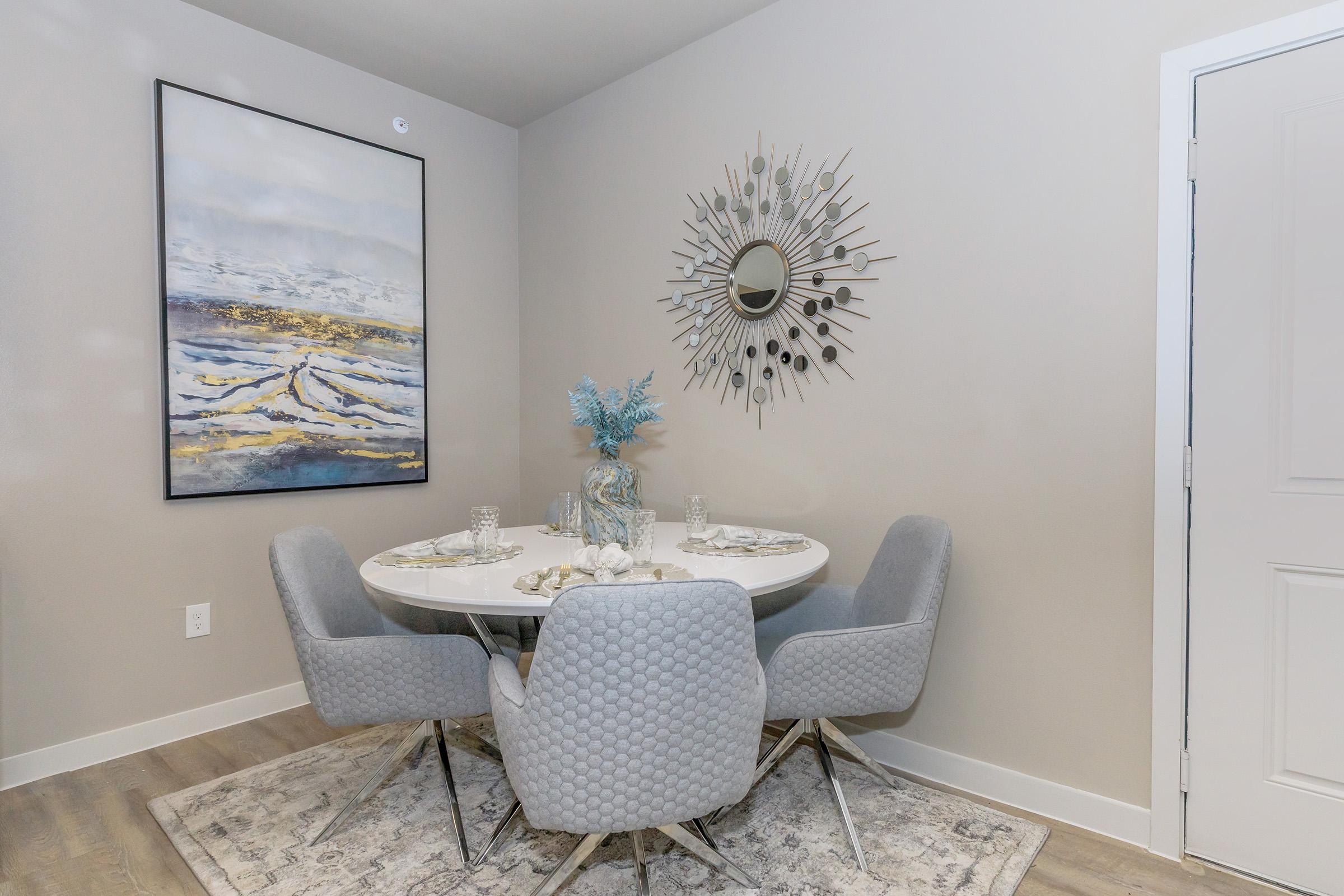 a room filled with furniture and vase of flowers on a table