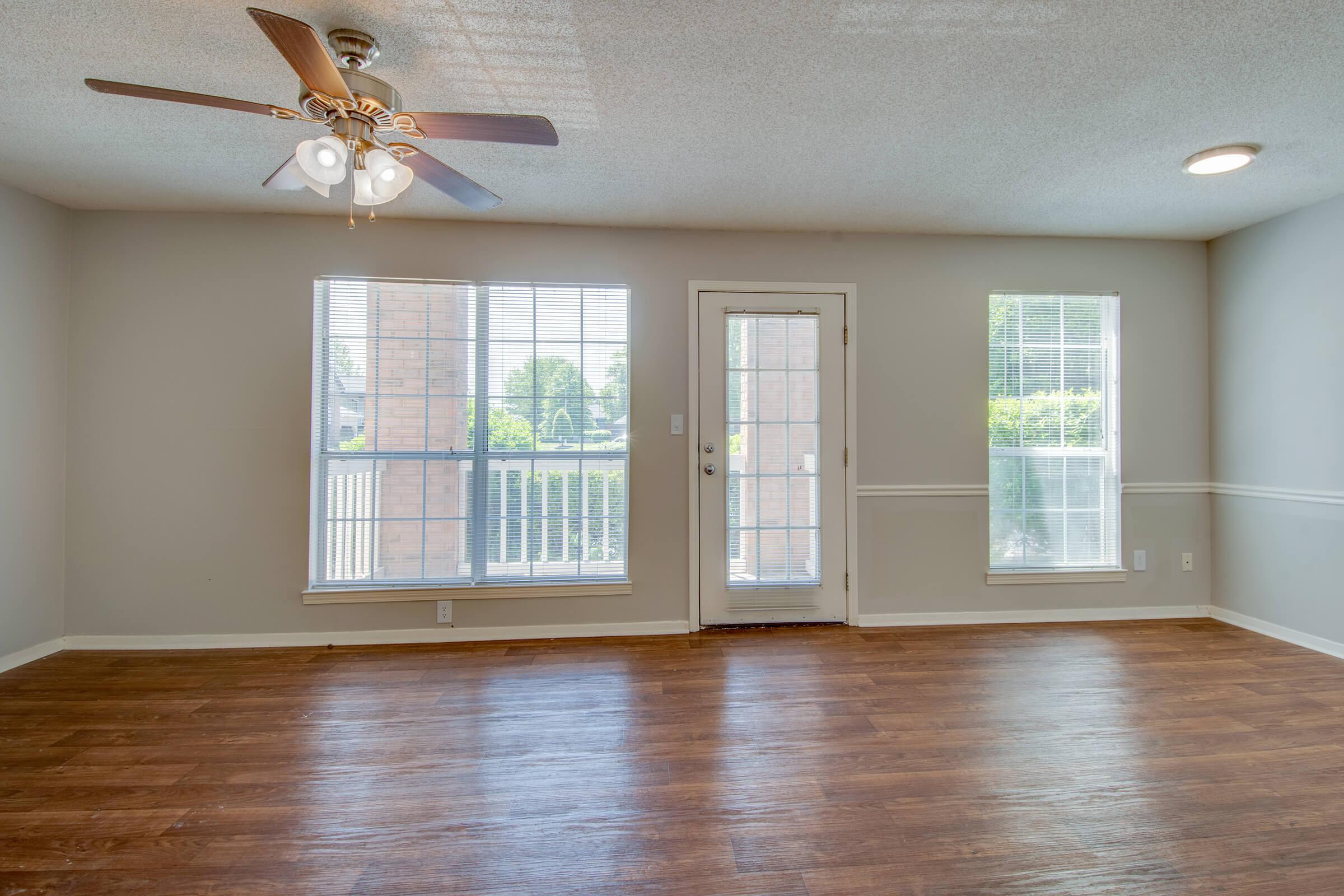 a close up of a hard wood floor next to a window