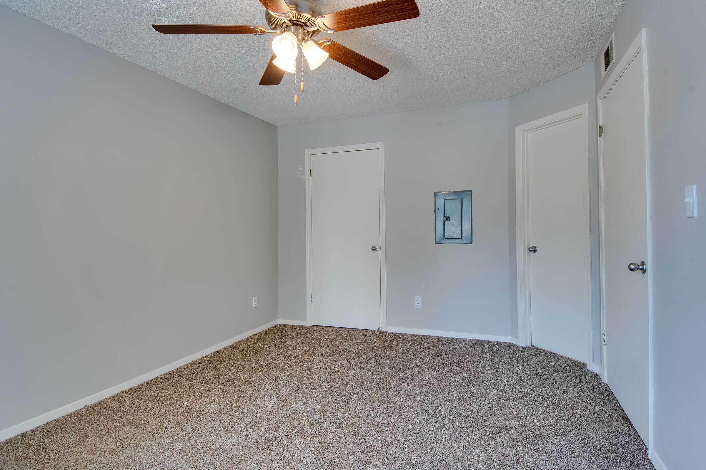a bedroom with a ceiling fan