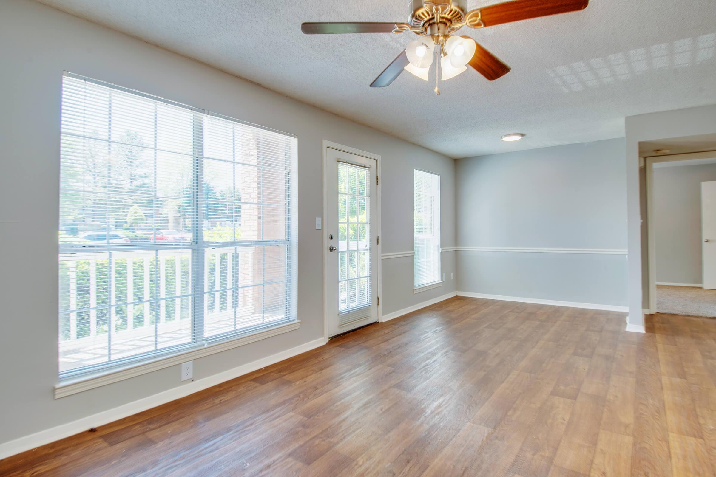 a close up of a hard wood floor next to a window