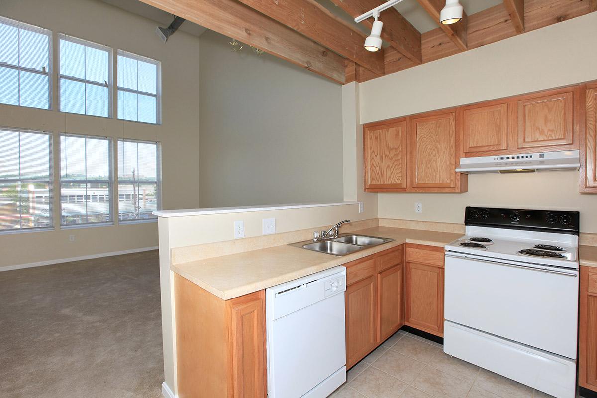 a kitchen with a stove a sink and a window