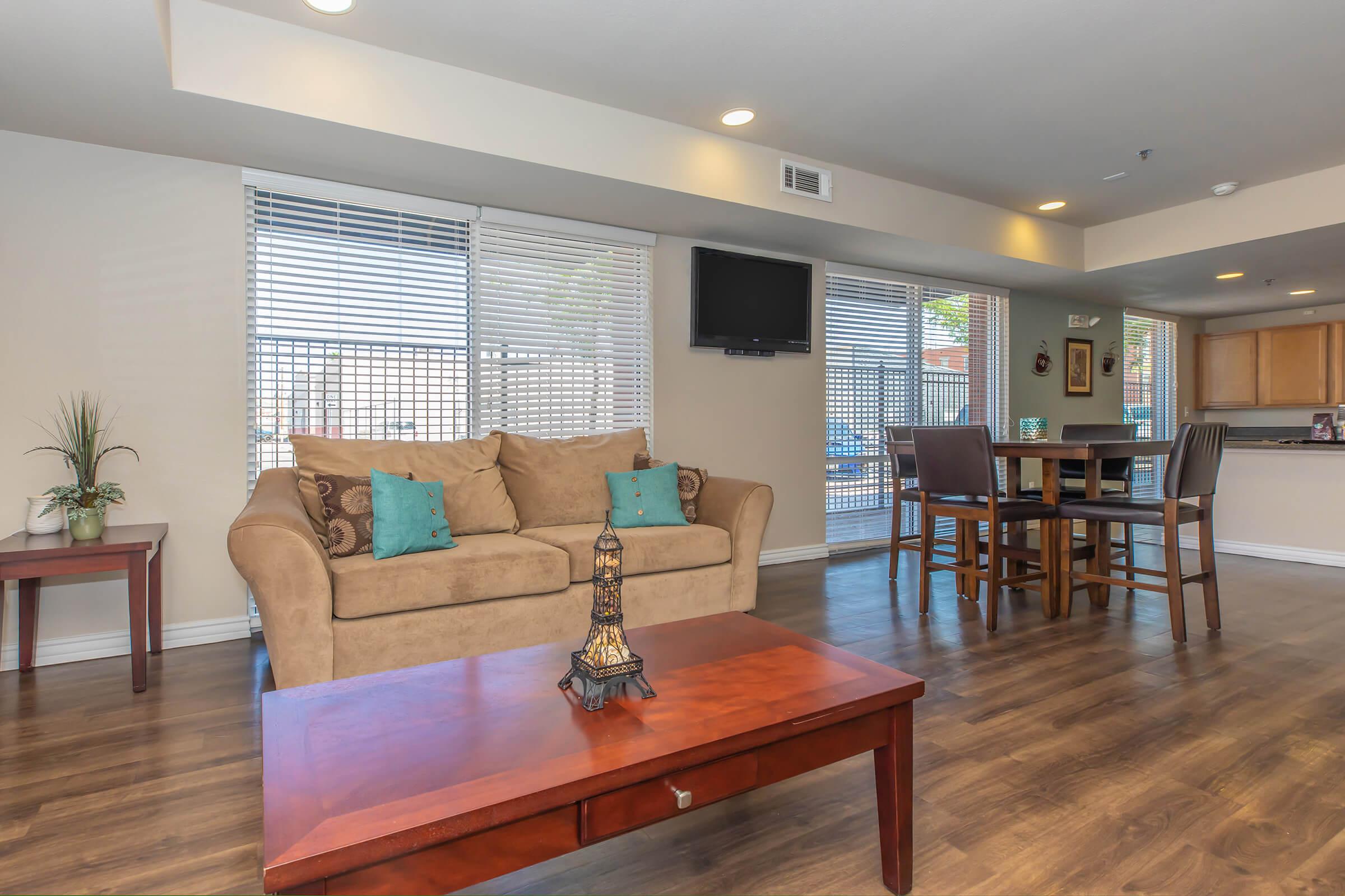 a living room filled with furniture and a flat screen tv