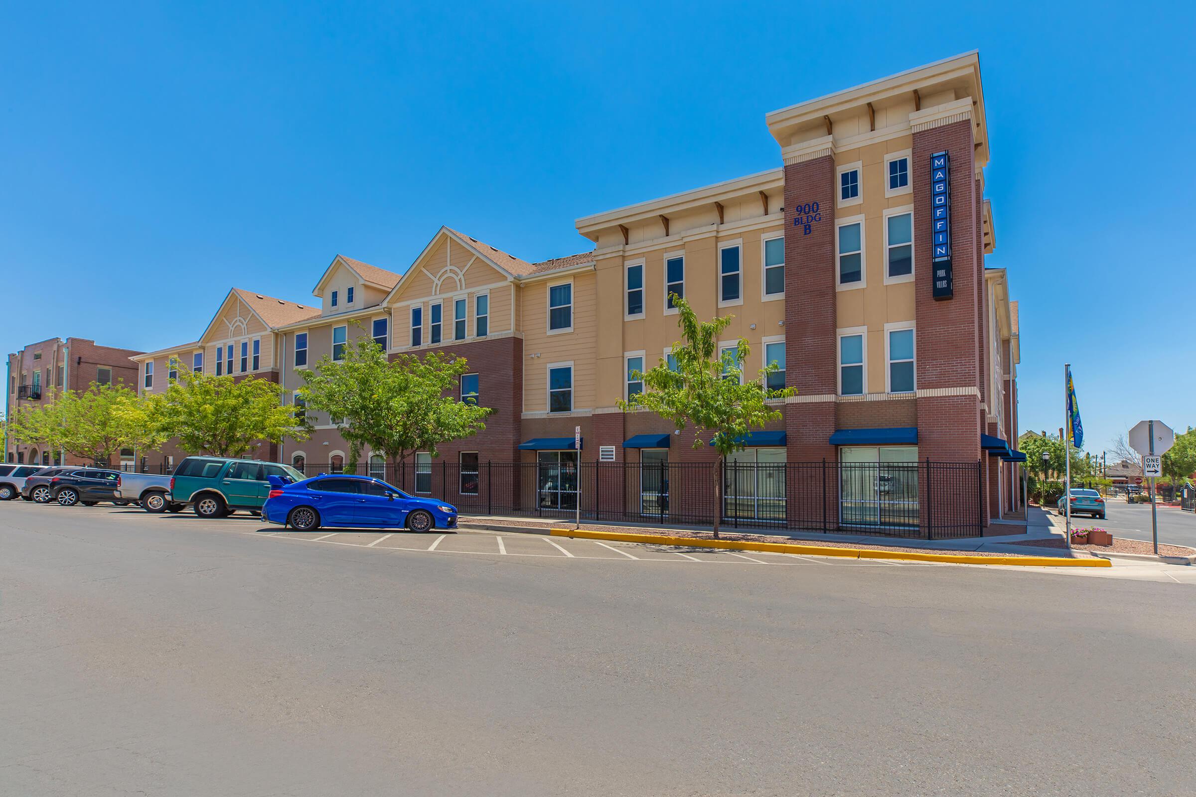 a street with cars parked on the side of a building