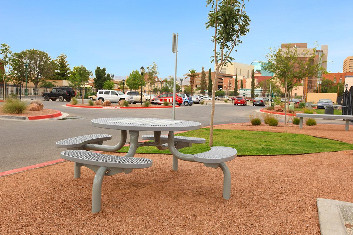 an empty park bench sitting in the grass