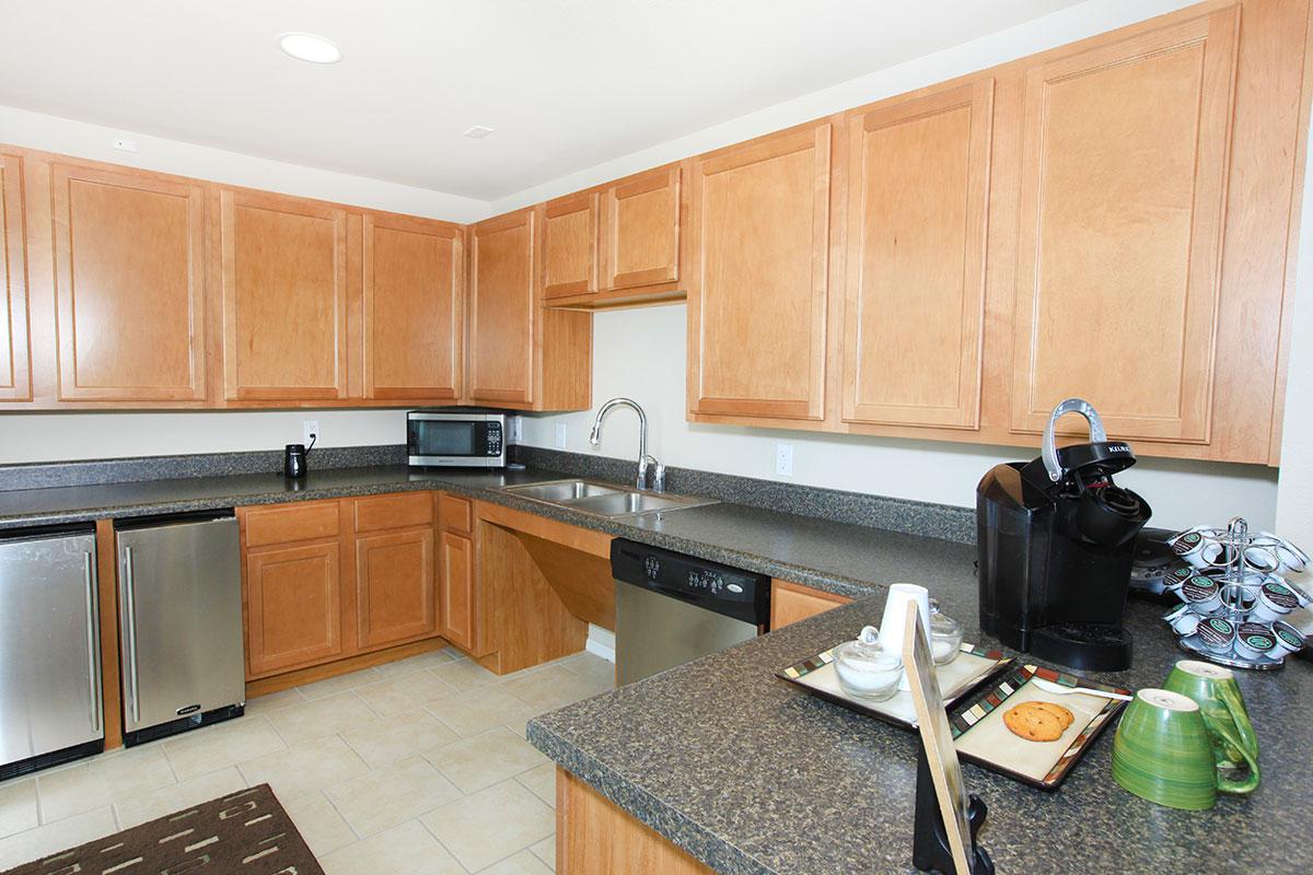 a kitchen with stainless steel appliances and wooden cabinets