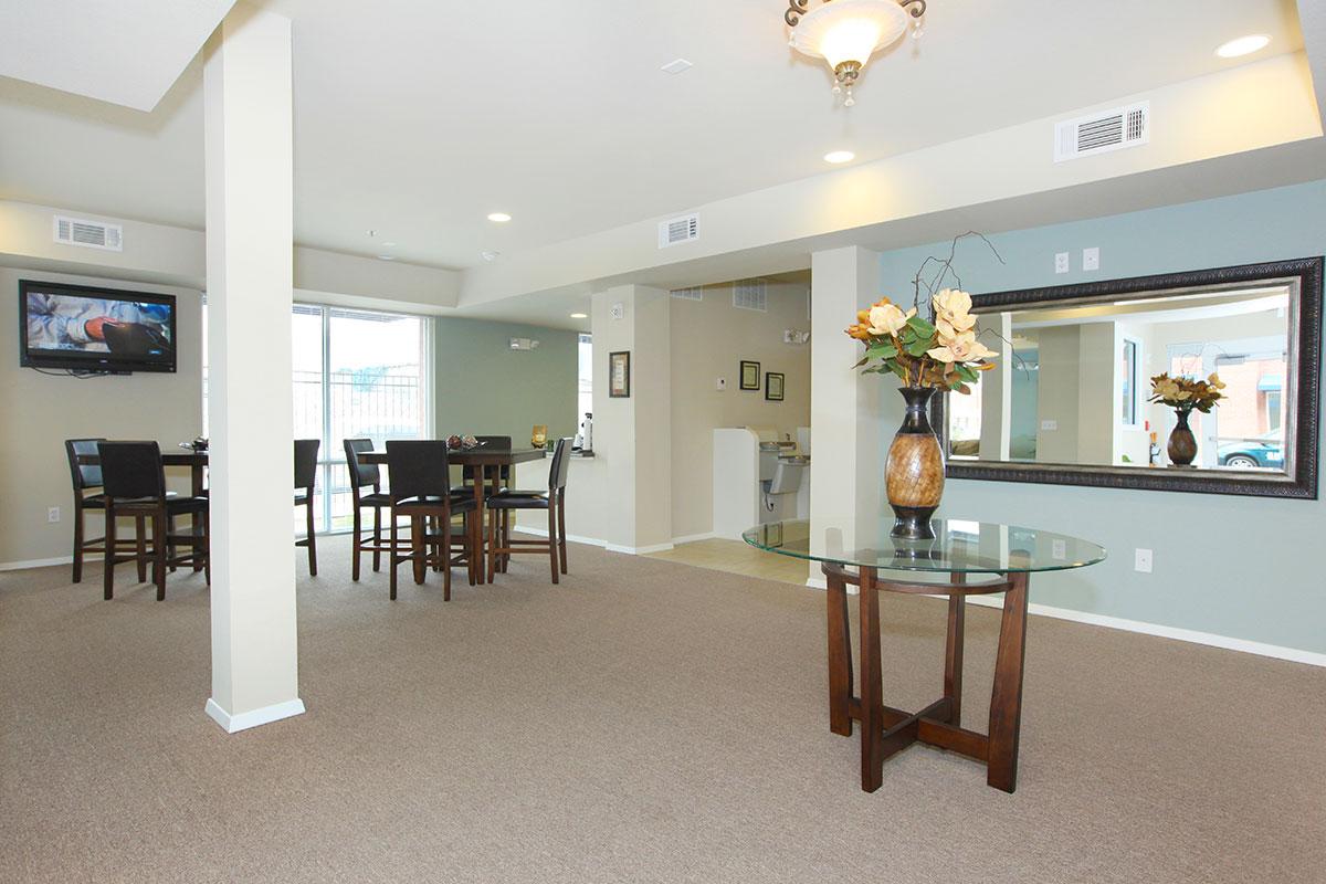 a living room filled with furniture and a large window