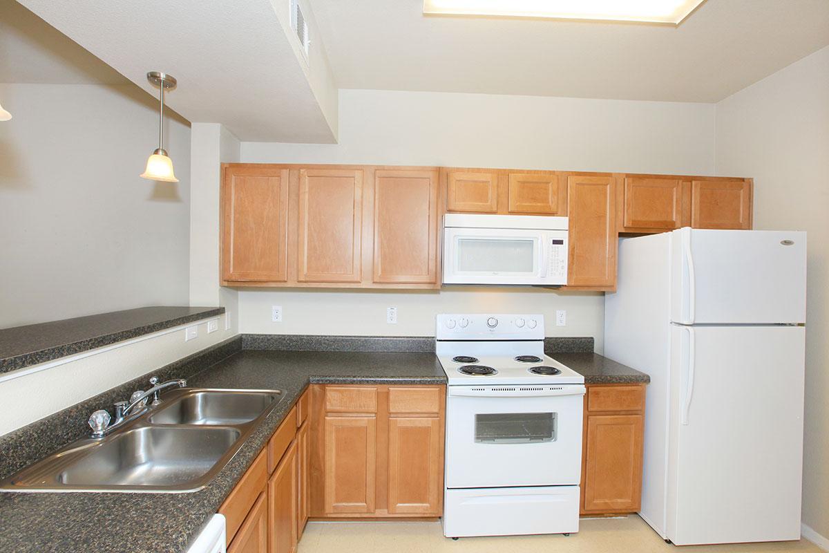 a kitchen with stainless steel appliances and wooden cabinets