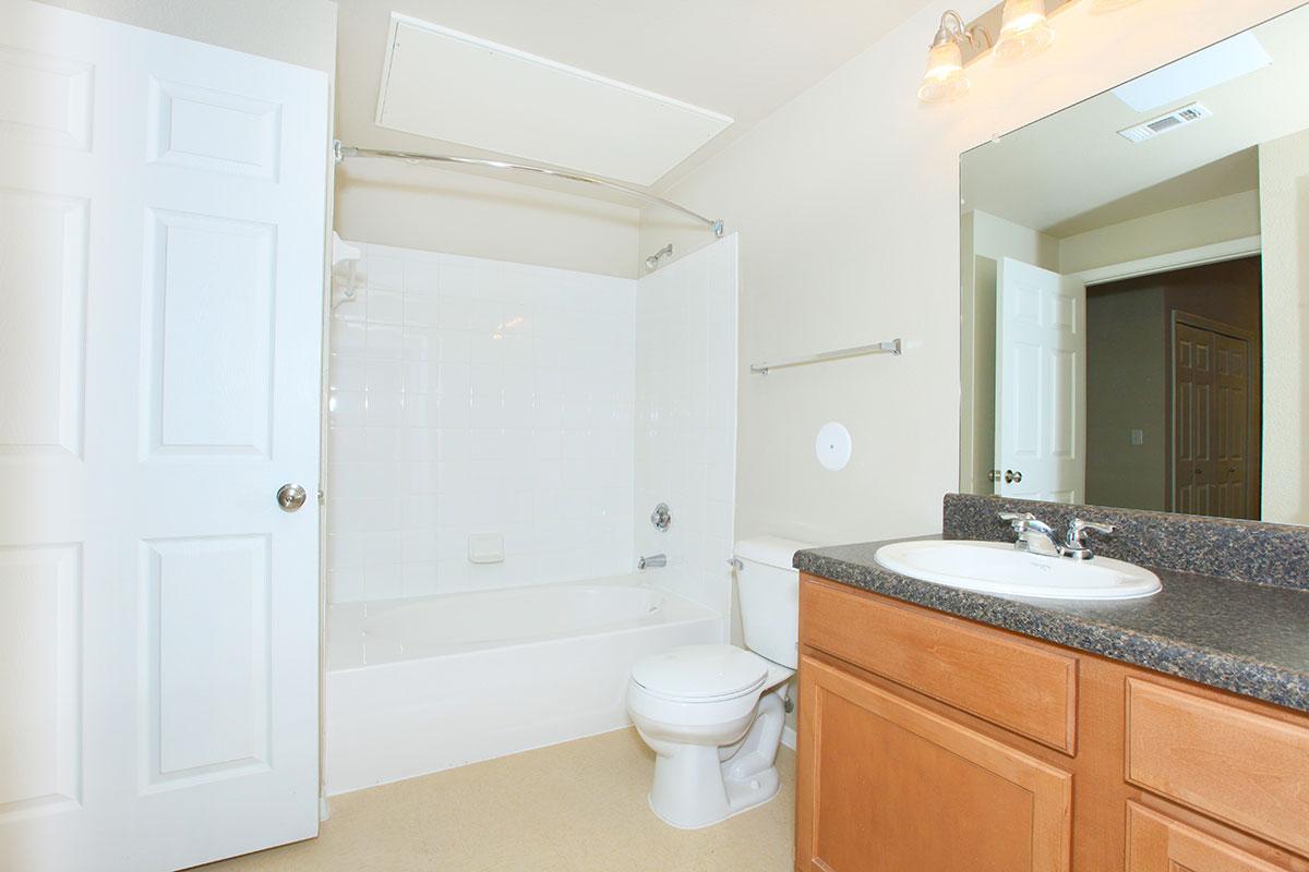 a kitchen with a sink and a mirror