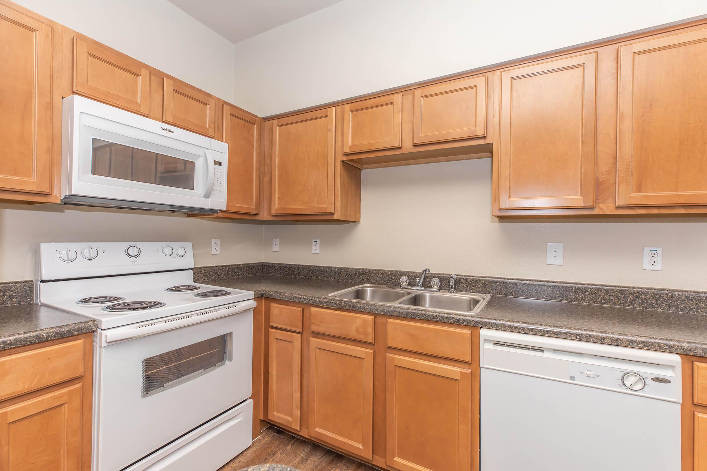 a kitchen with stainless steel appliances and wooden cabinets