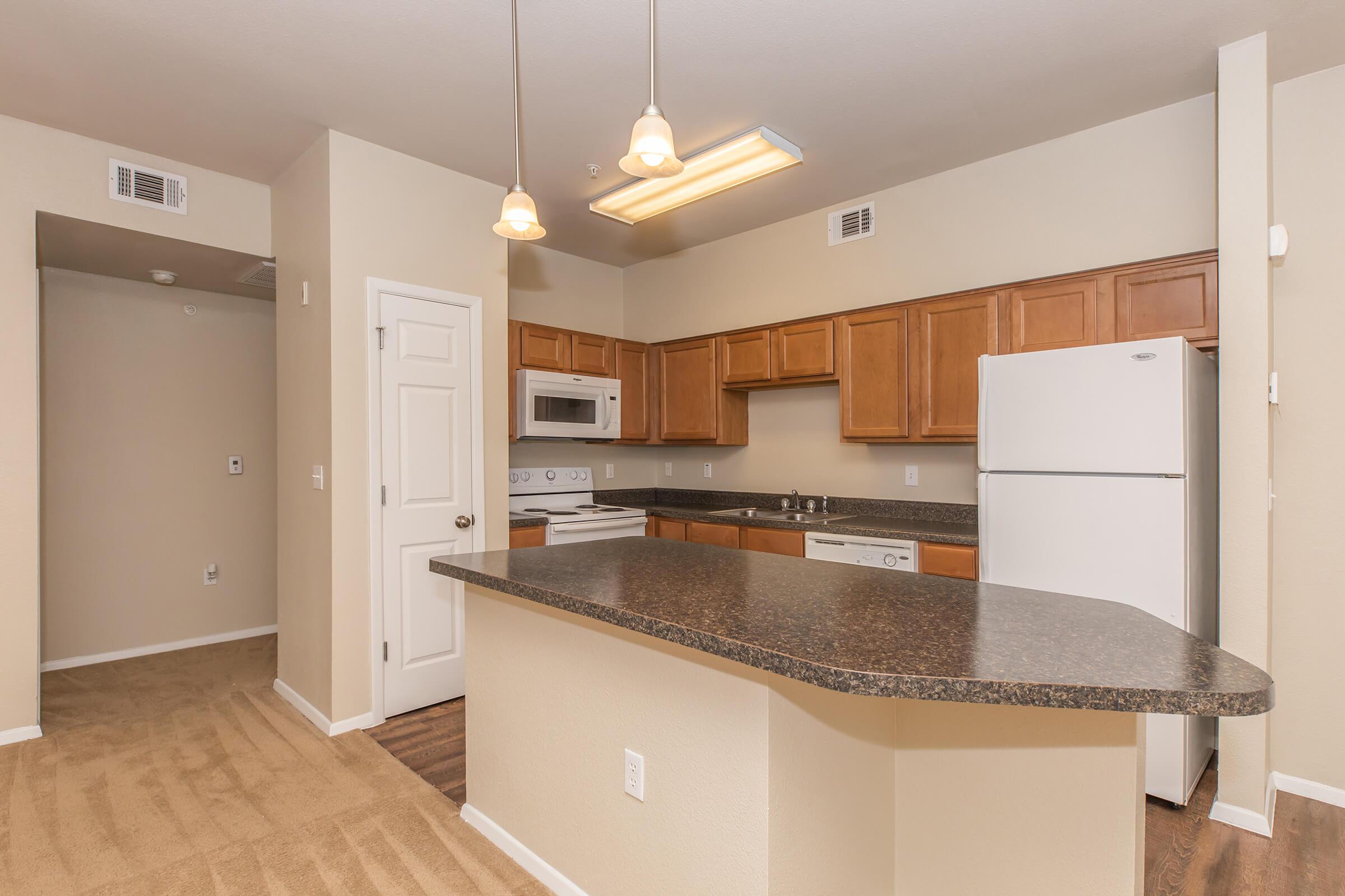 a kitchen with a sink and a mirror