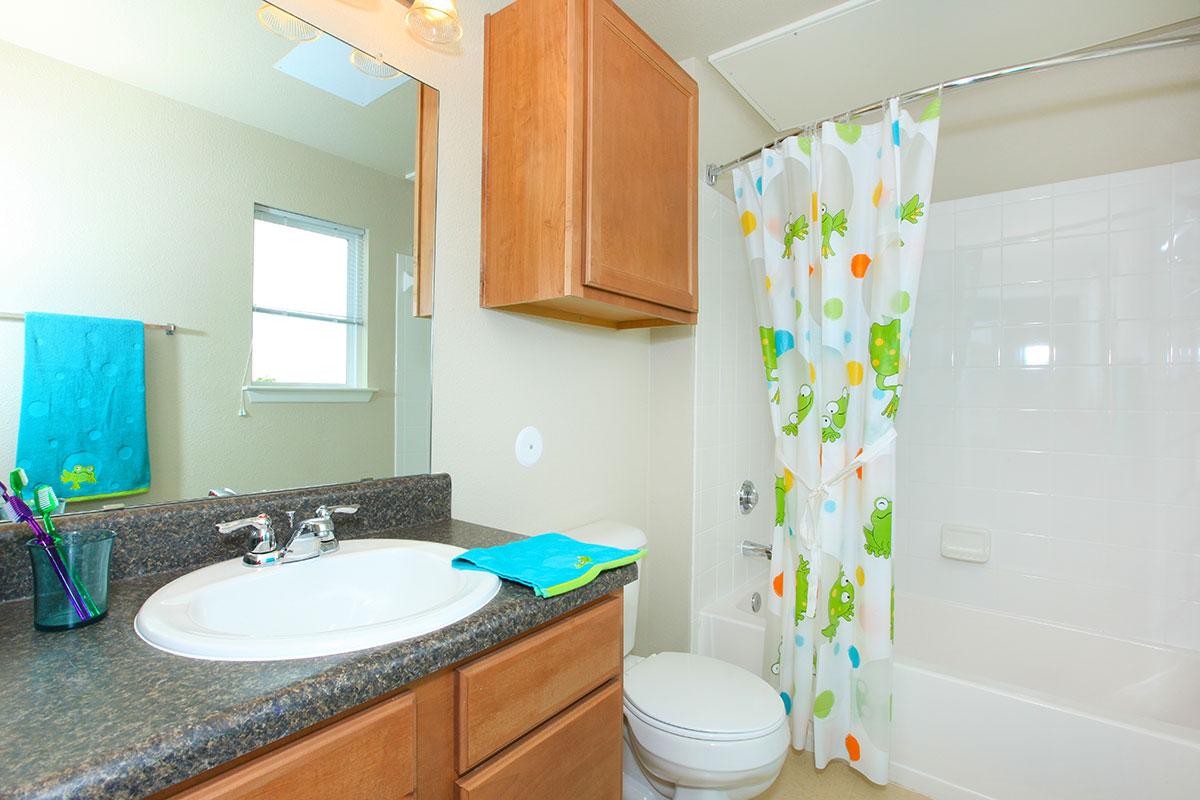 a kitchen with a sink and a mirror