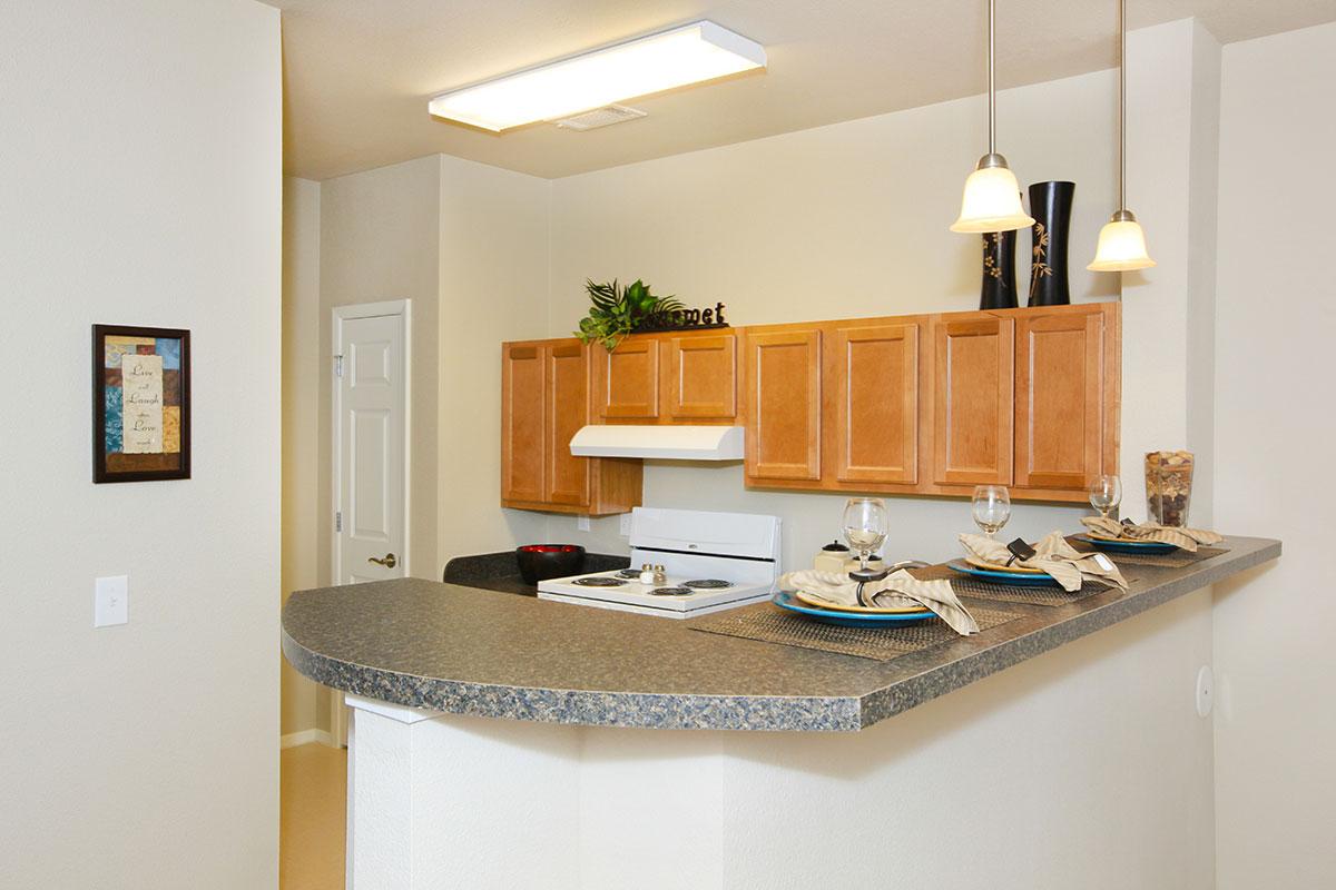 a kitchen with a sink and a mirror