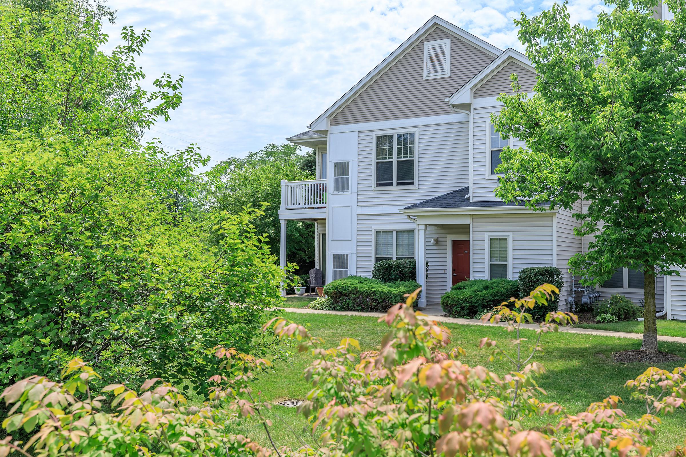 a house with bushes in front of a building