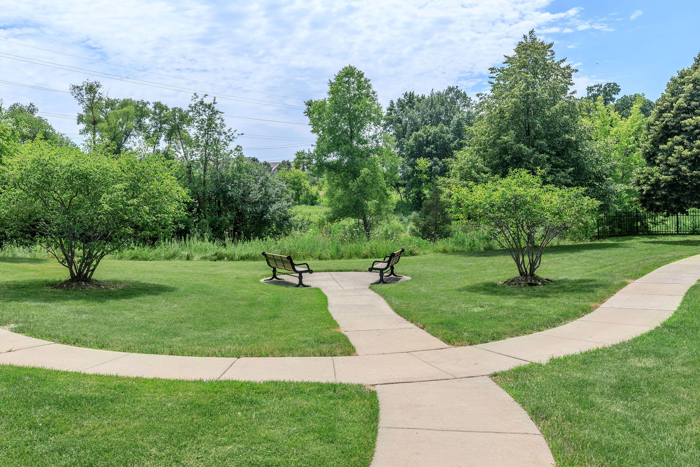 a group of lawn chairs sitting on top of a grass covered field