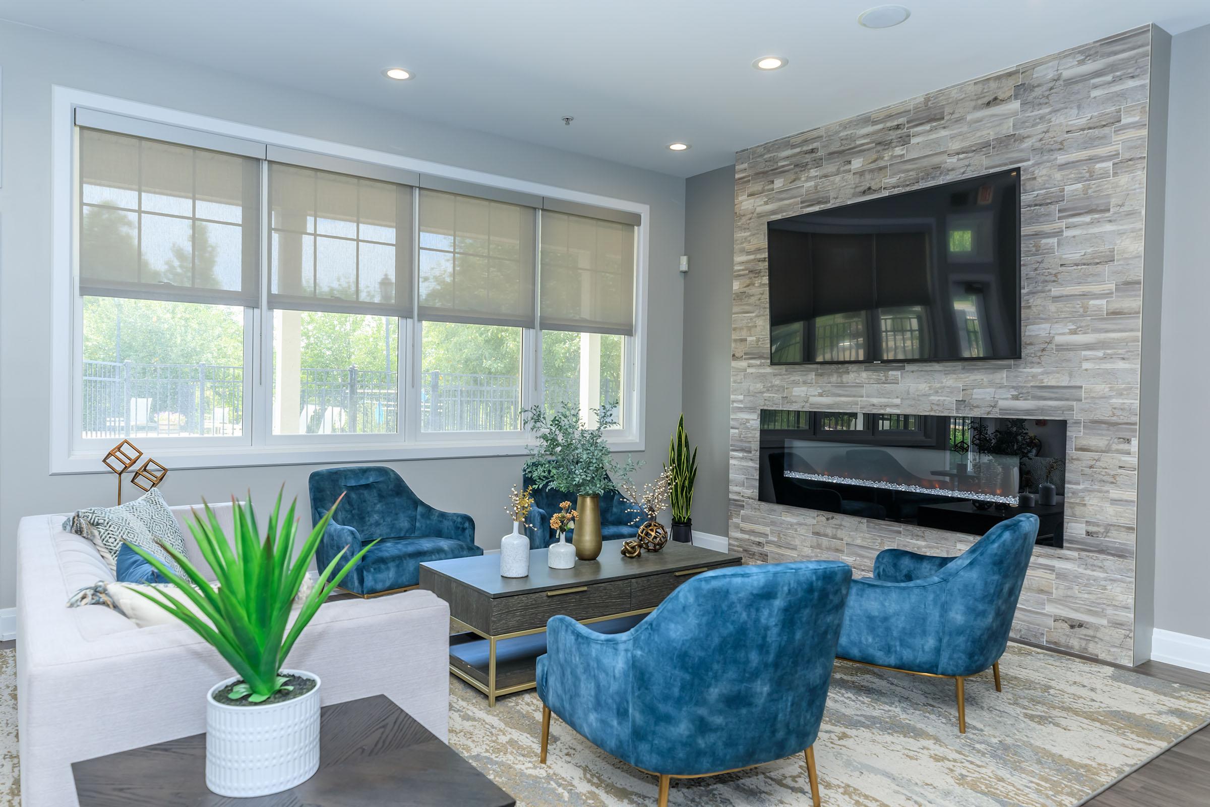 a living room filled with furniture and a large window