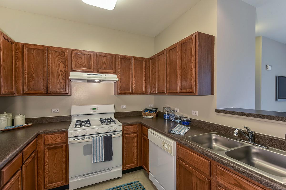 a kitchen with stainless steel appliances and wooden cabinets