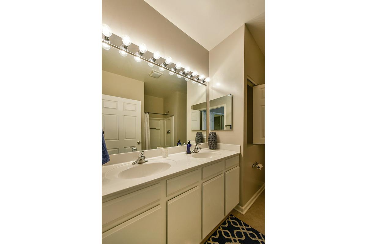 a kitchen with a sink and a mirror