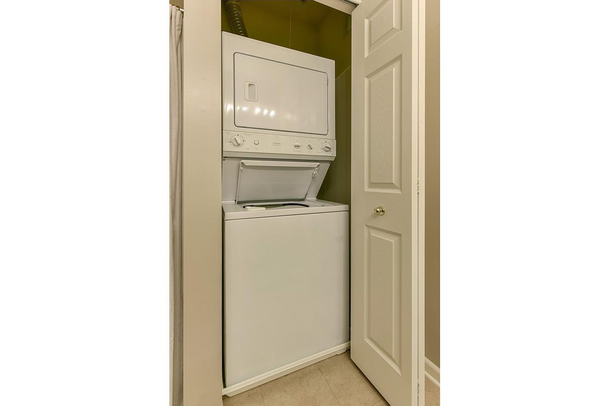 a white refrigerator freezer sitting next to a door