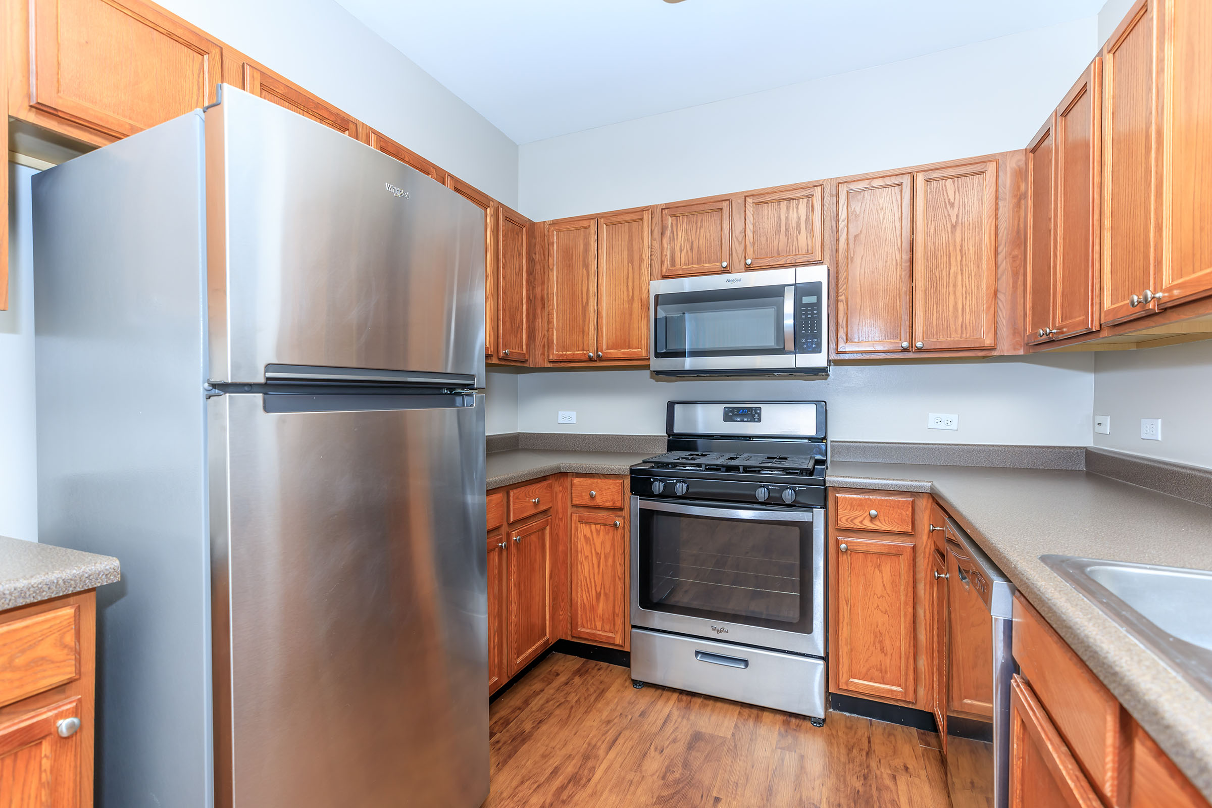 a kitchen with stainless steel appliances and wooden cabinets