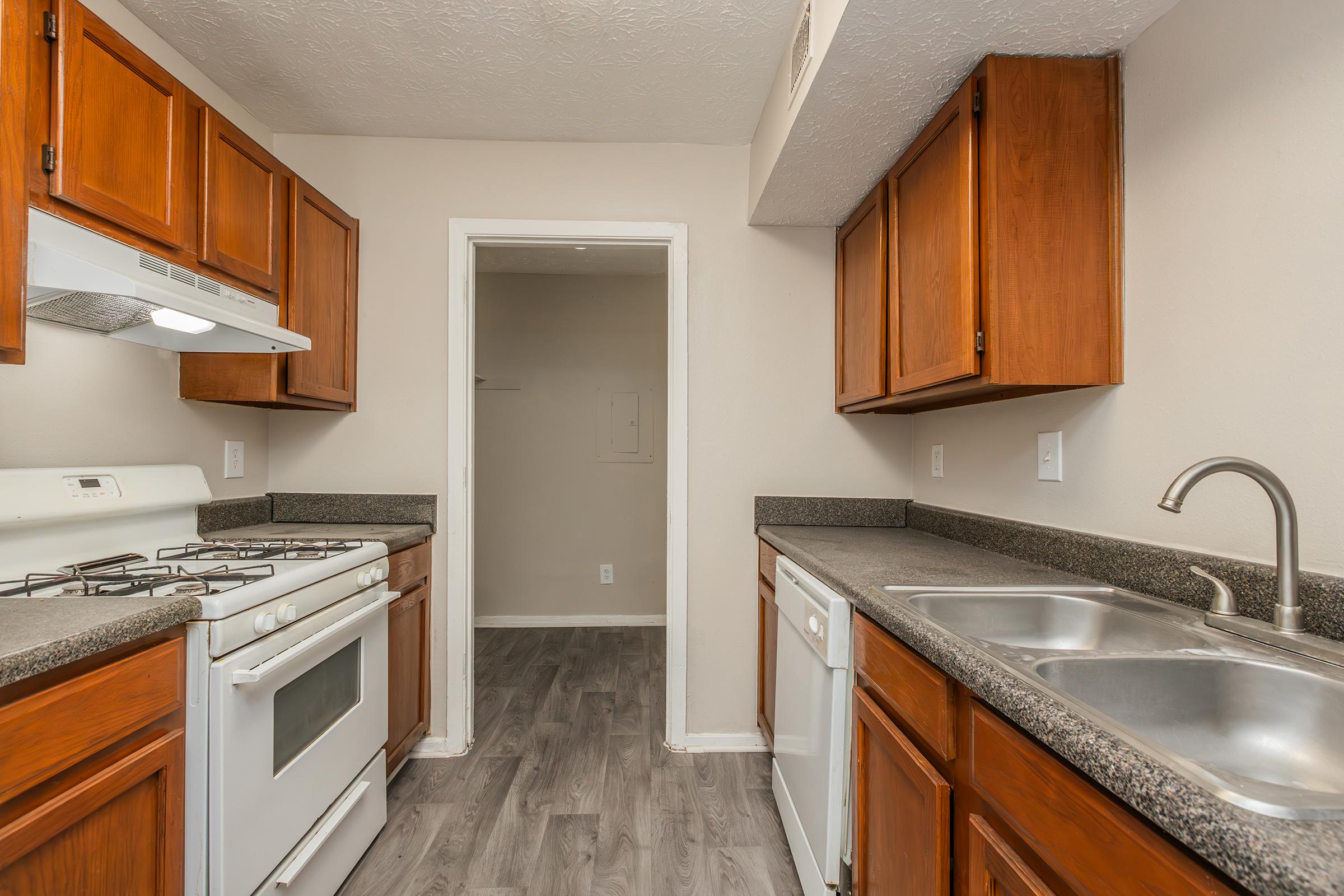 a kitchen with a stove sink and refrigerator