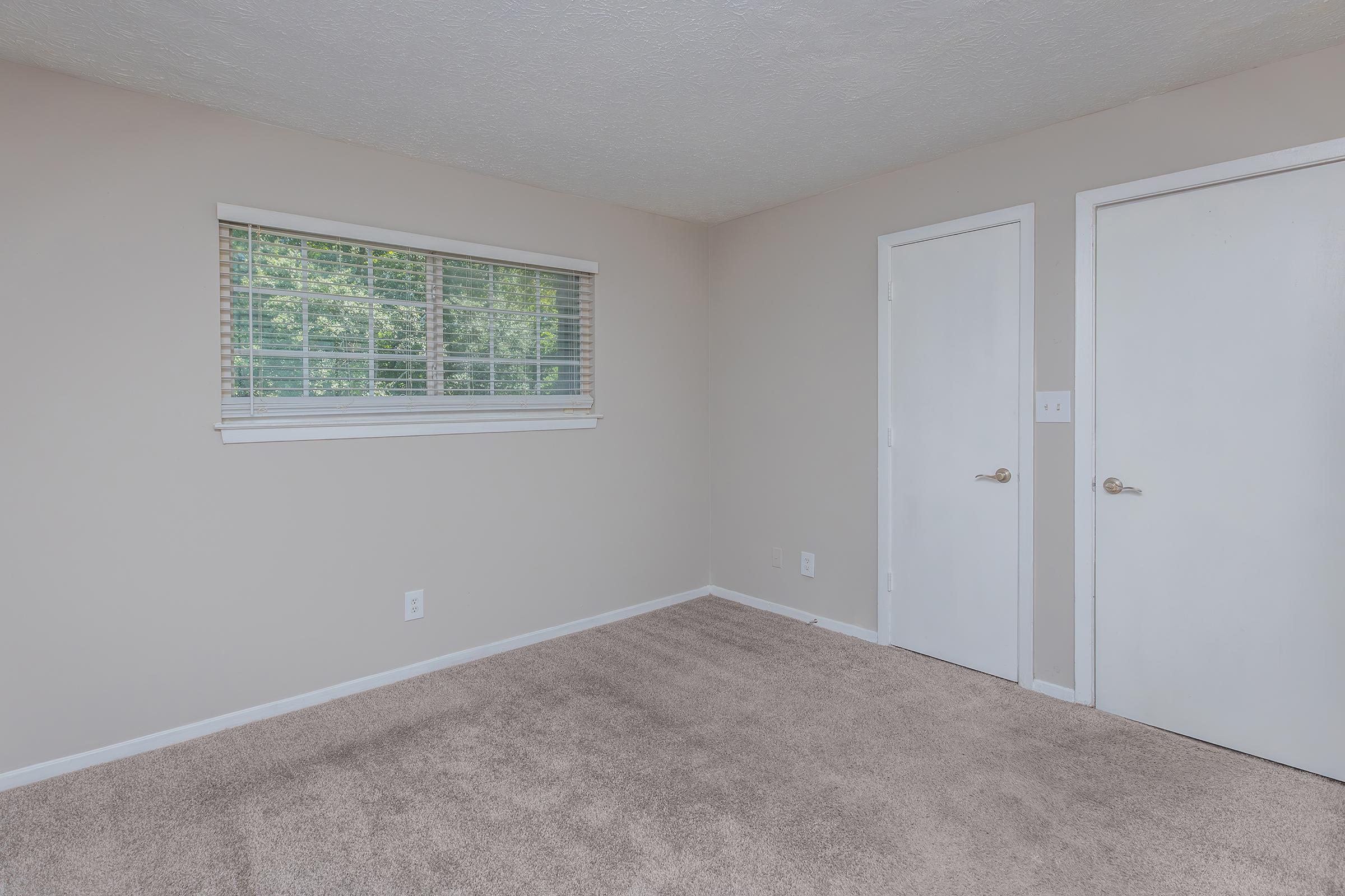 a bedroom with a large window