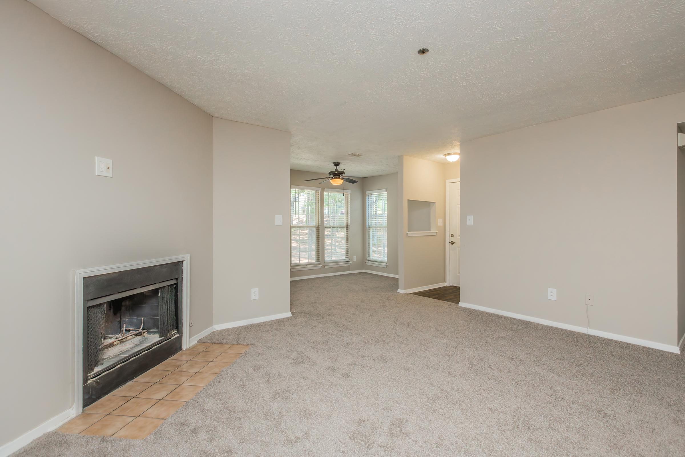 a living room filled with furniture and a flat screen tv