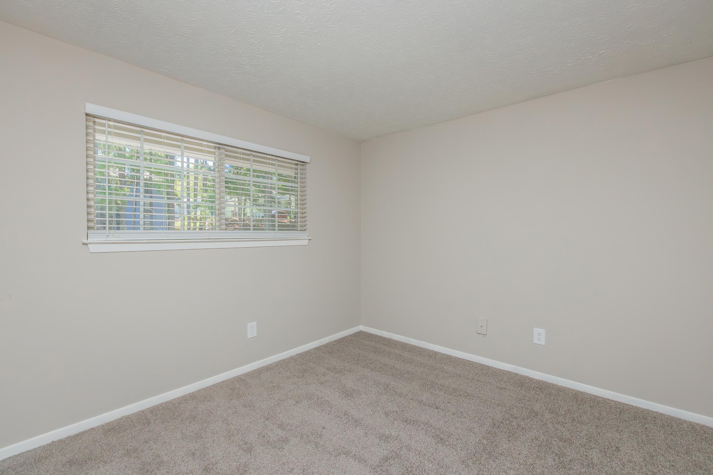 a bedroom with a large window