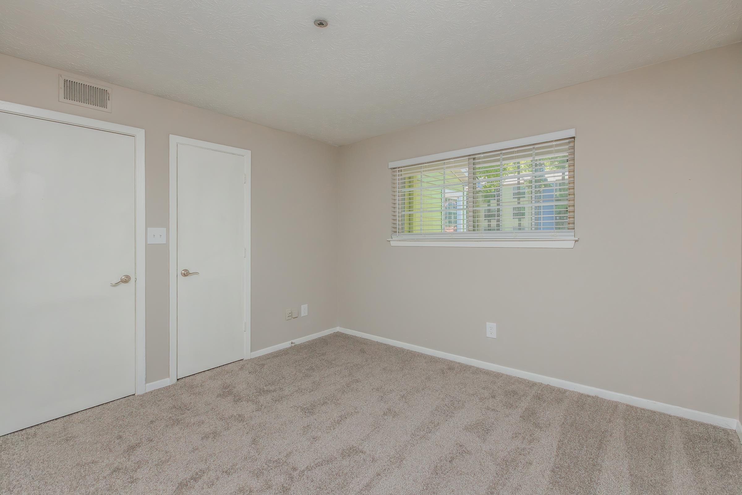 a bedroom with a large mirror