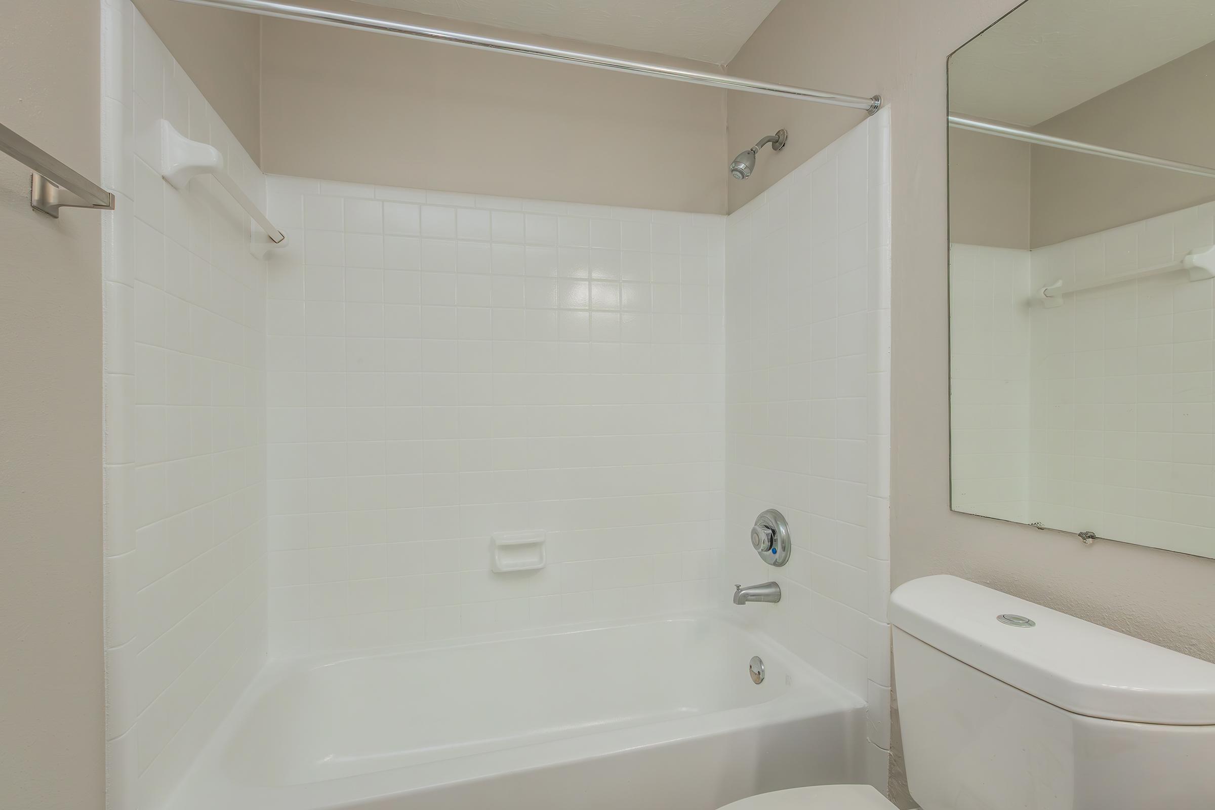 a sink and a white tub sitting next to a shower