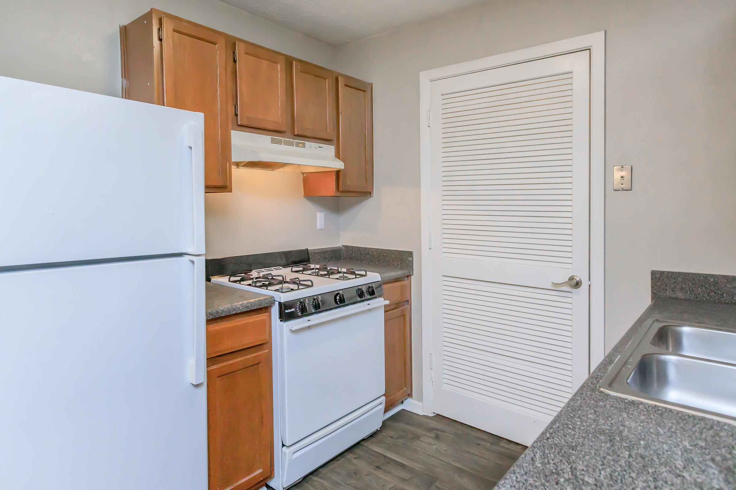 a kitchen with a stove top oven sitting inside of a refrigerator