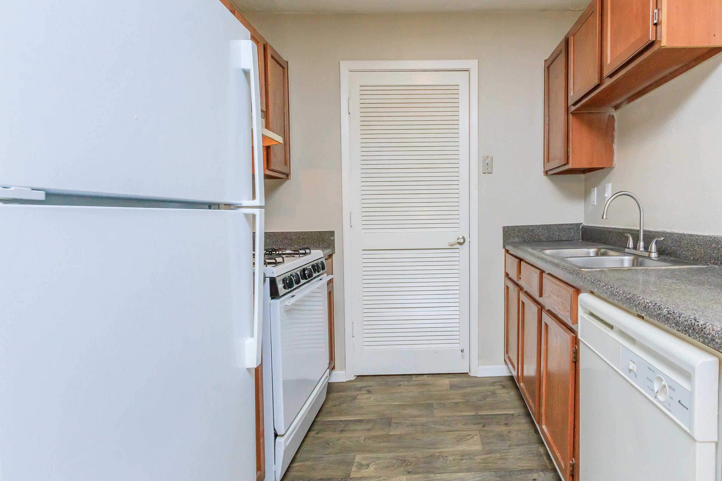 a kitchen with a stove and a refrigerator