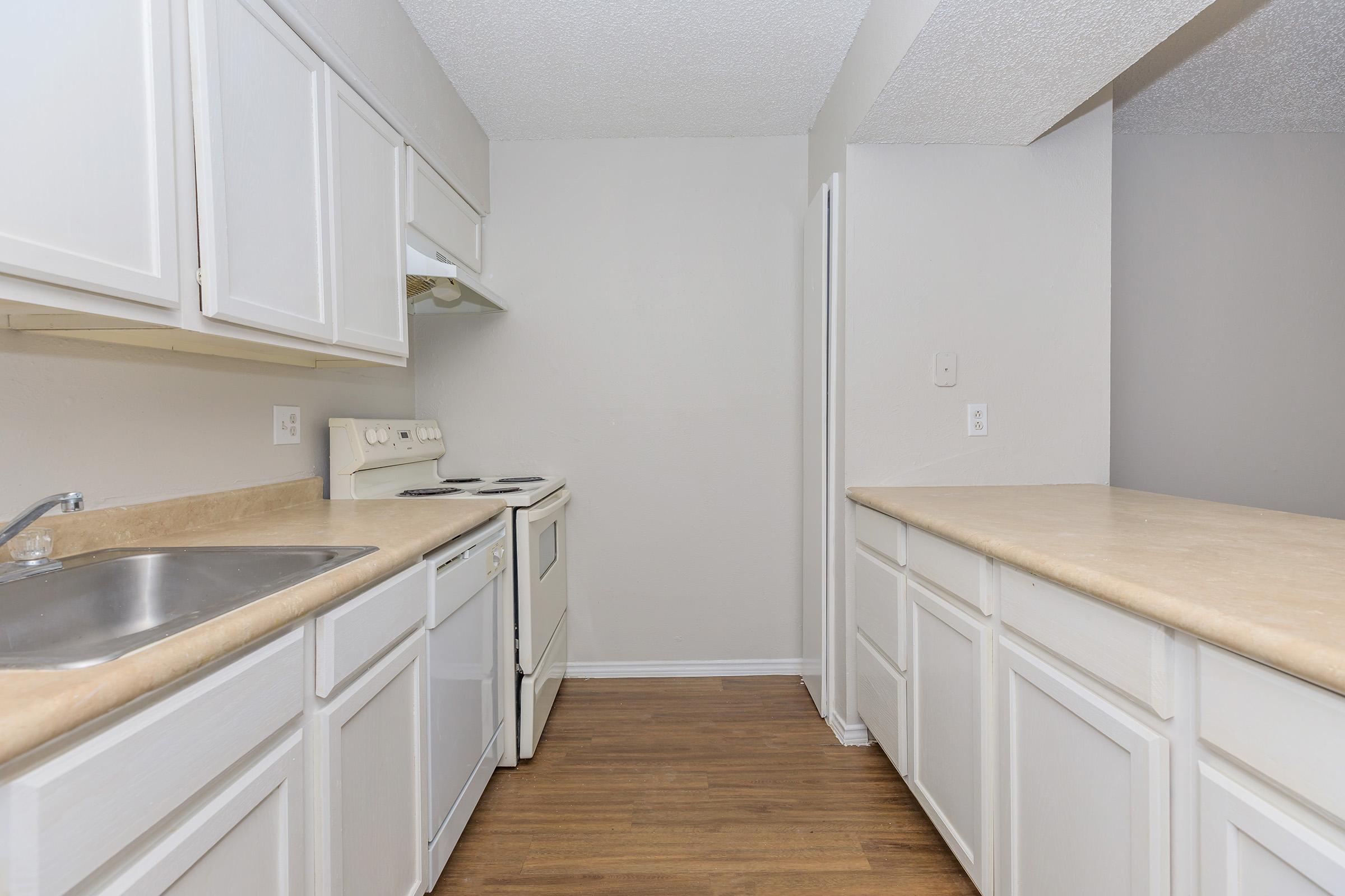 a kitchen with a stove and a sink