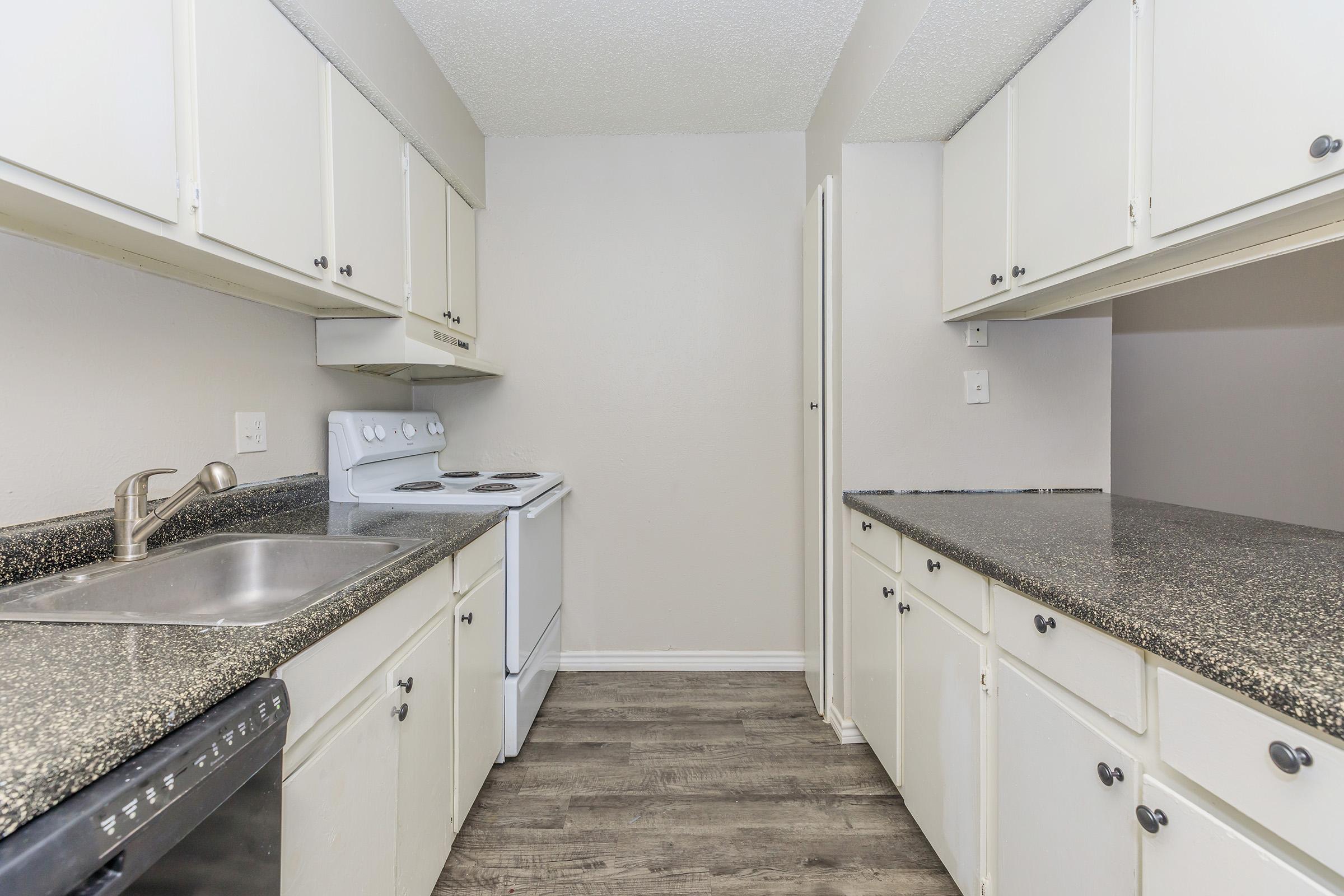 a kitchen with a stove and a sink