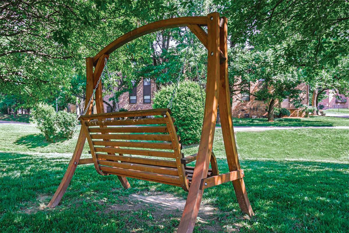 a couple of lawn chairs sitting on top of a wooden bench
