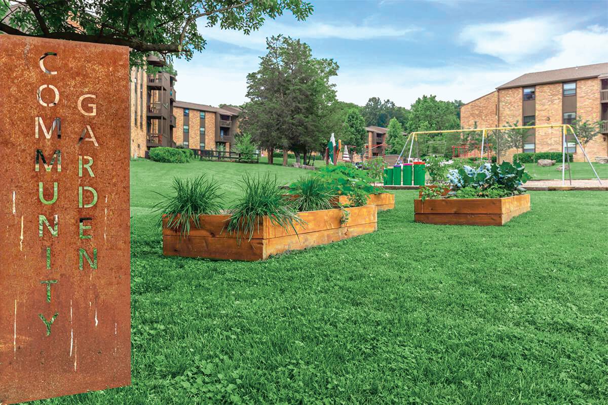 a large brick building with green grass