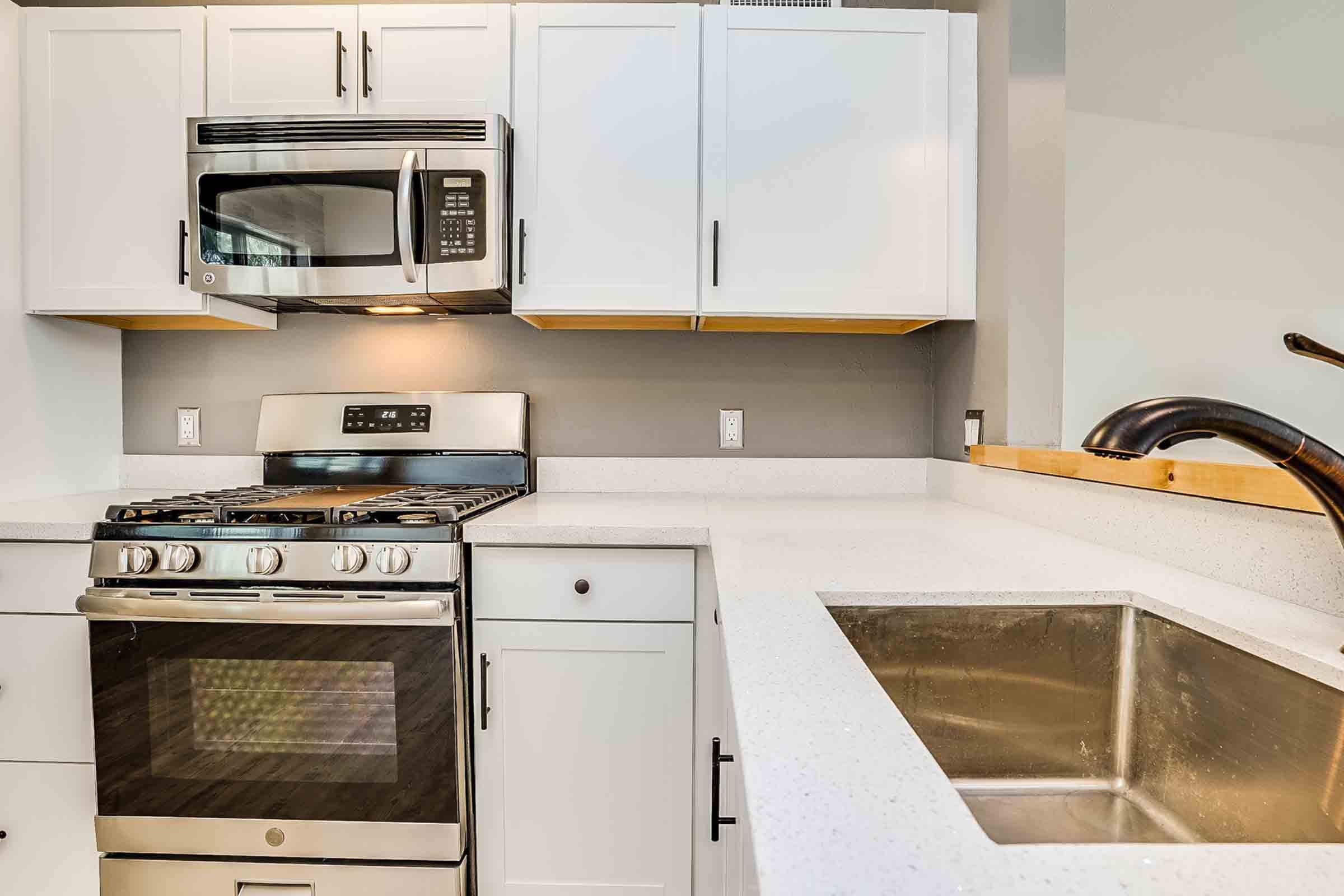 a stove top oven sitting inside of a kitchen