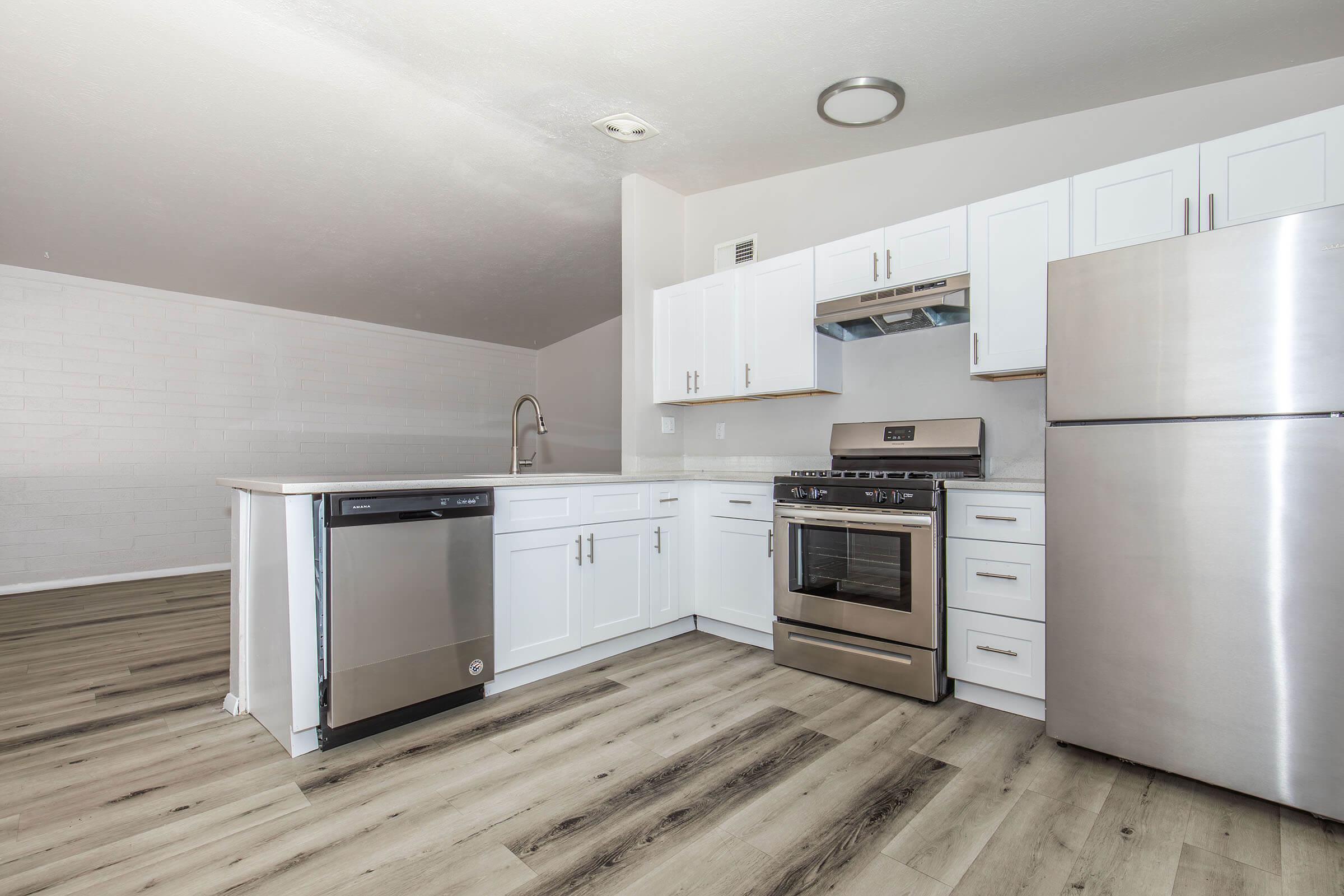 a kitchen with a stove and a refrigerator