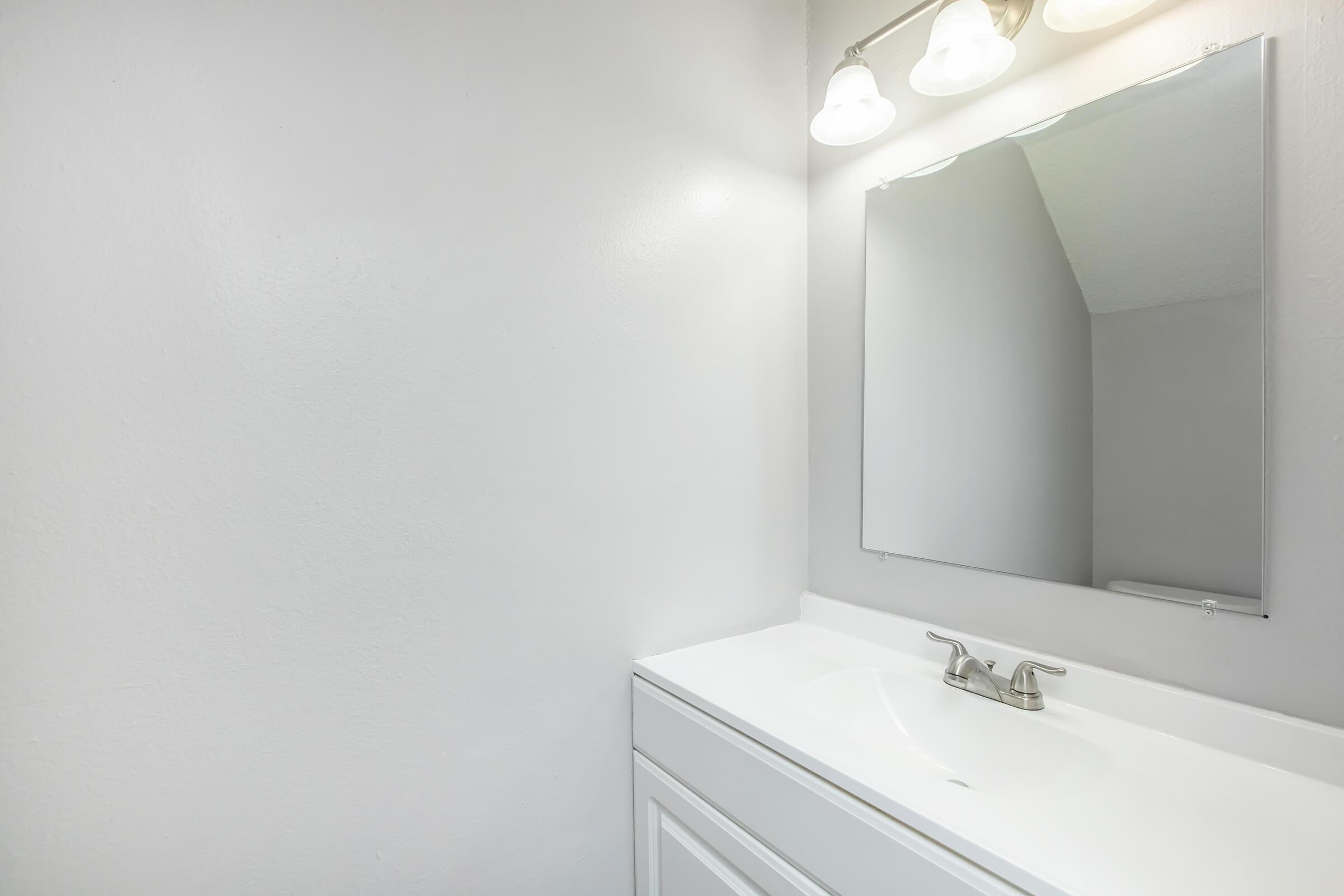 a close up of a sink and a mirror