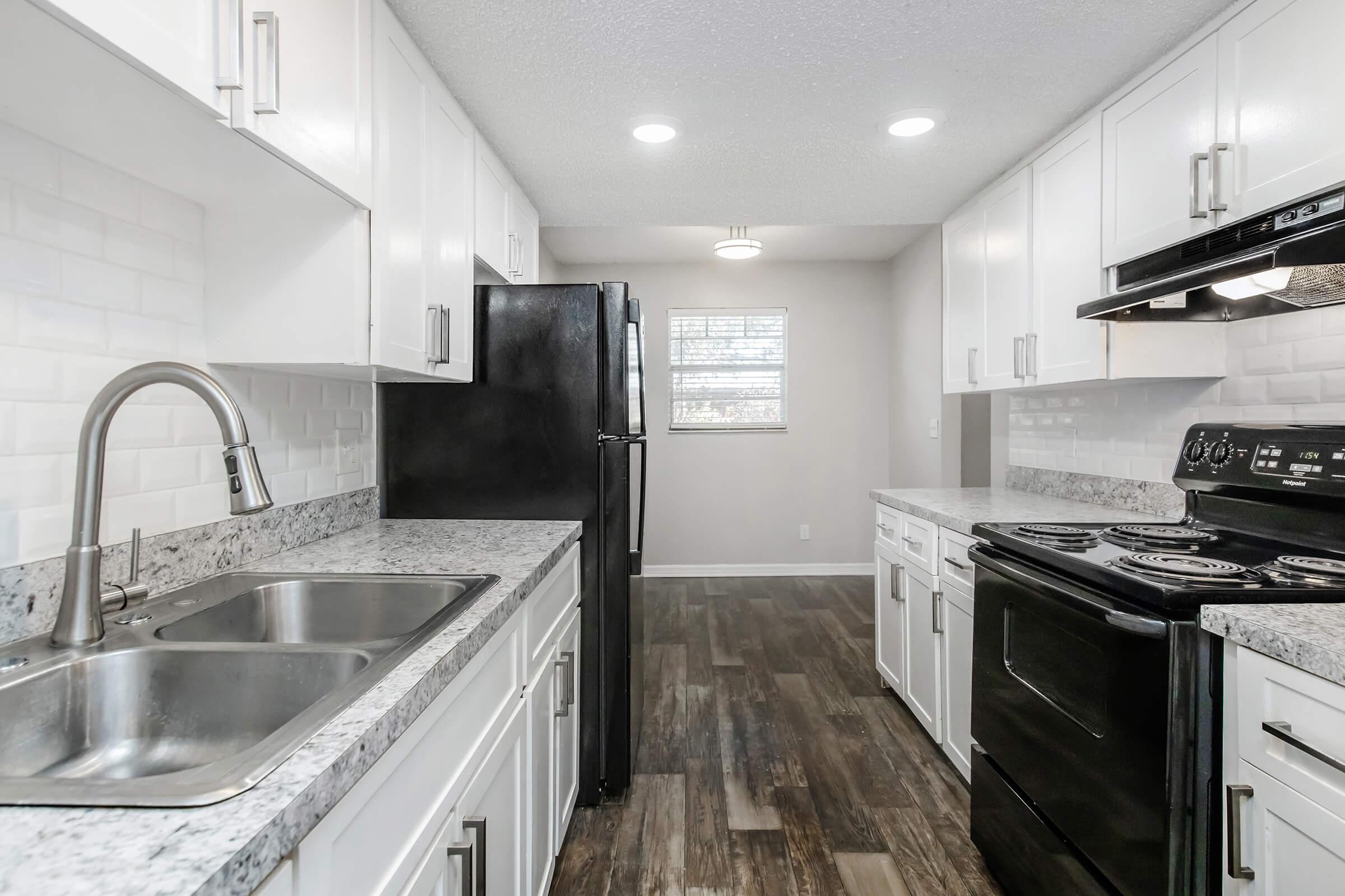 a large kitchen with stainless steel appliances