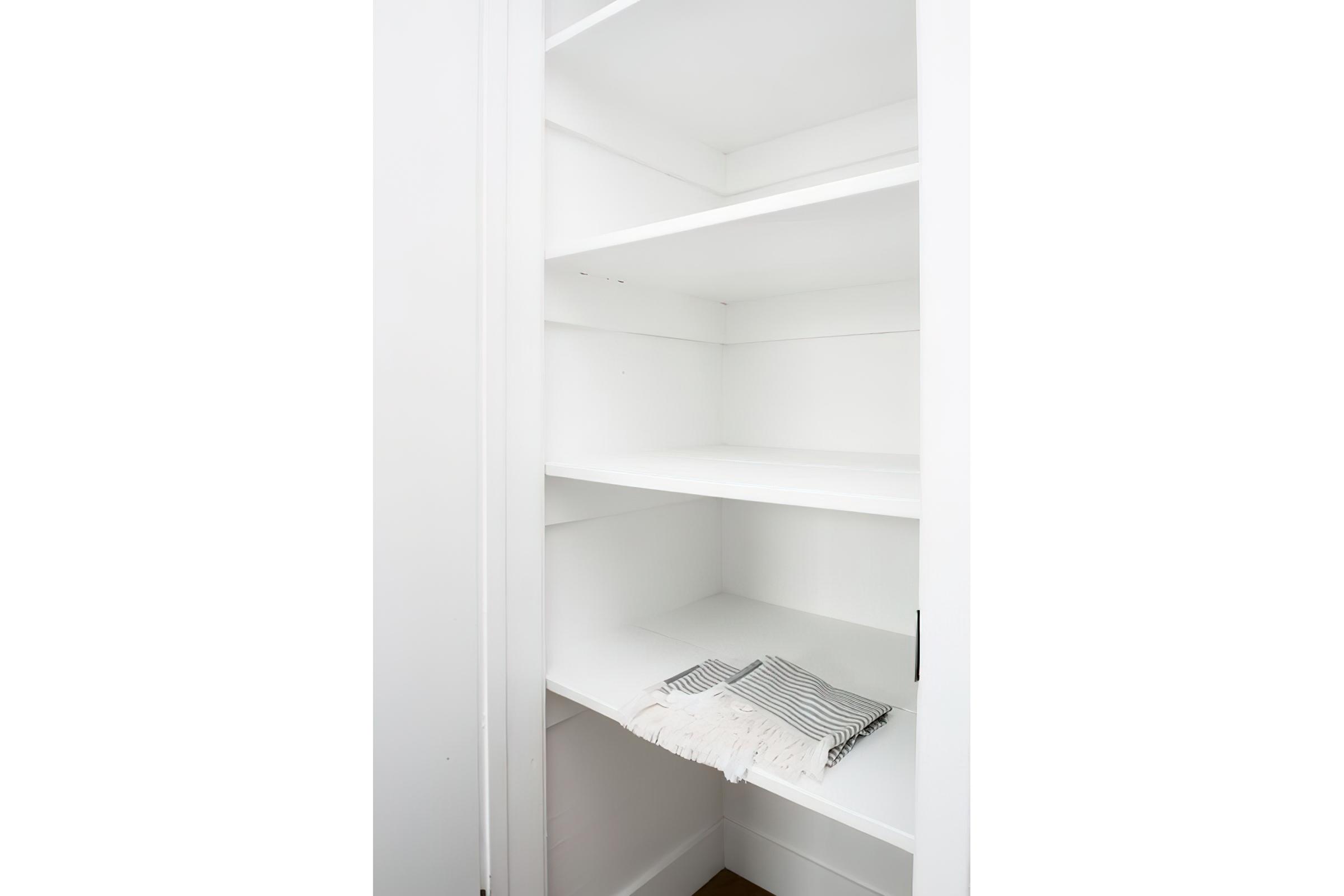 Linen closet in bathroom with shelving