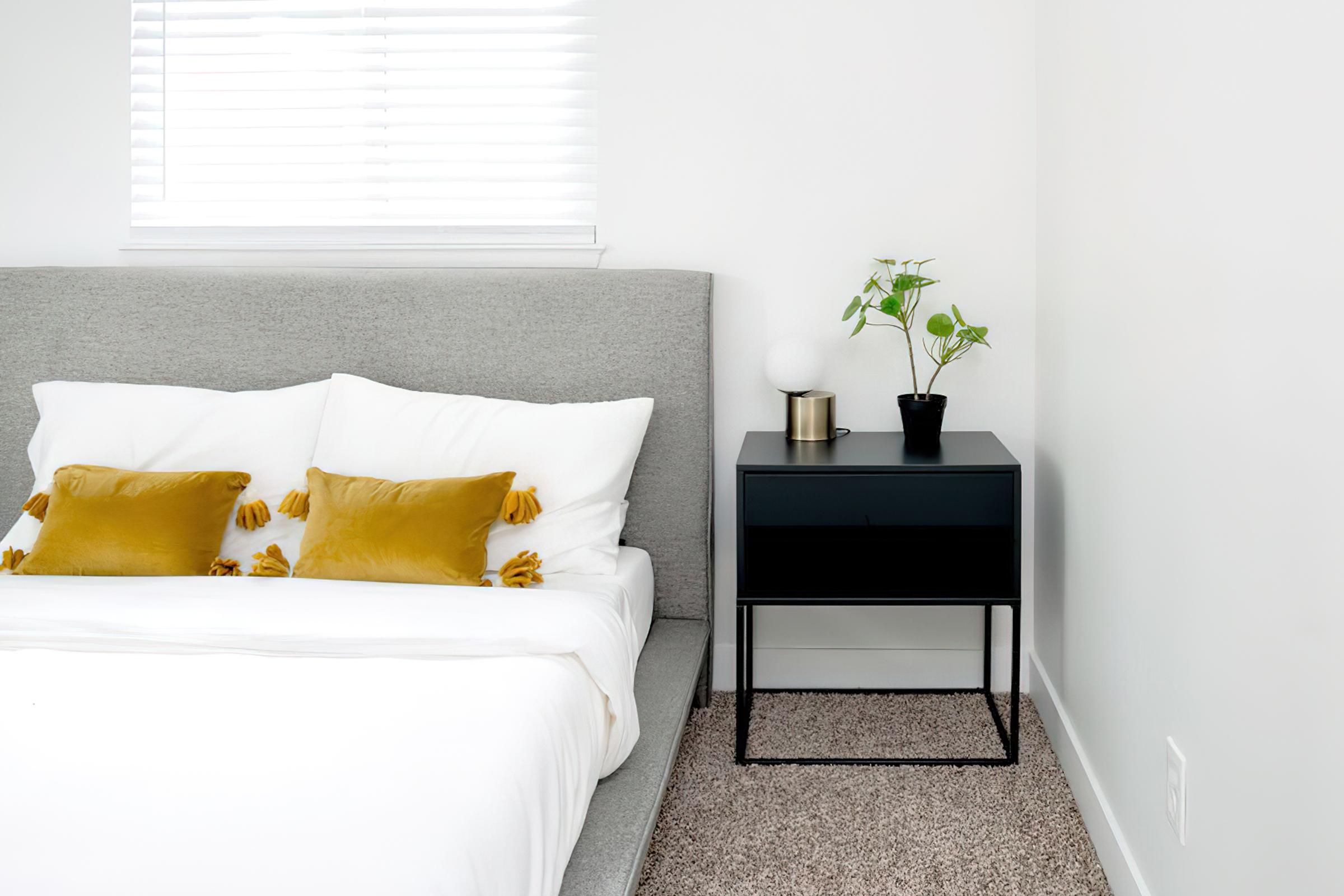 Second bedroom with full-size bed nightstand and window with blinds