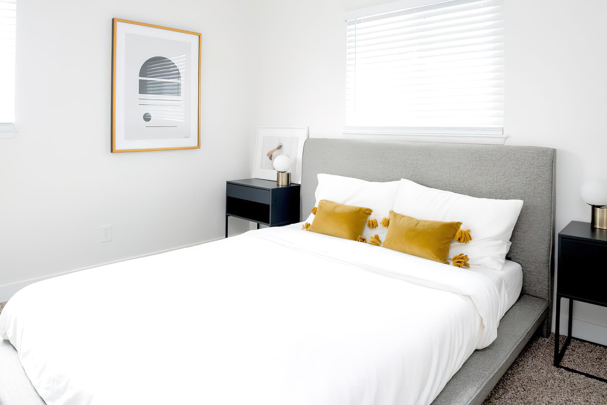 Full view of bed with nightstands and two windows