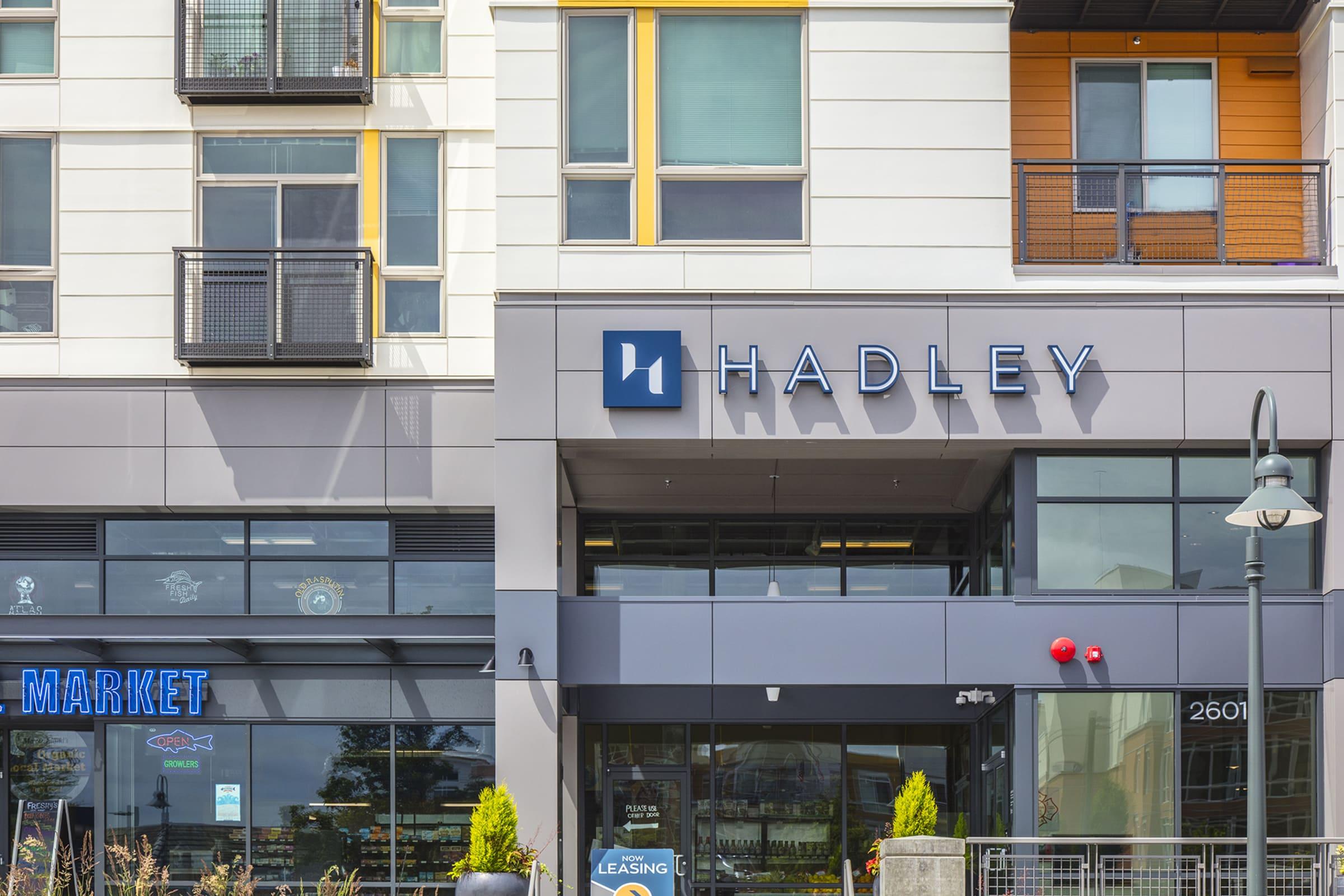 A modern building exterior showcasing the signage for "Hadley" above the entrance
