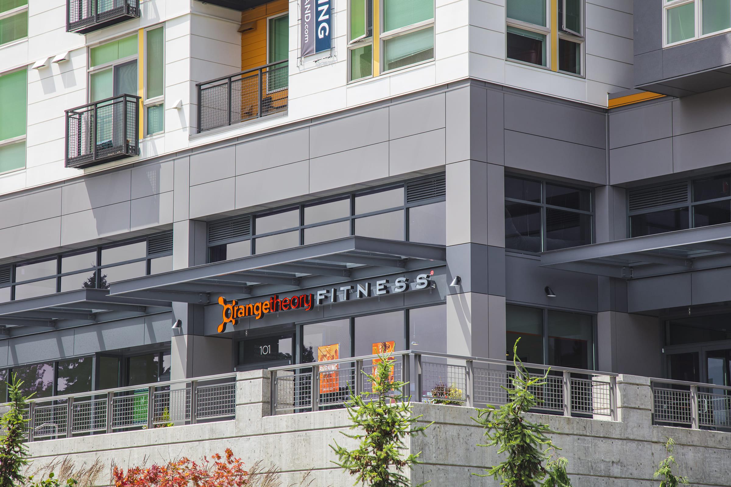 Exterior view of a modern building featuring the sign for "OrangeTheory Fitness."