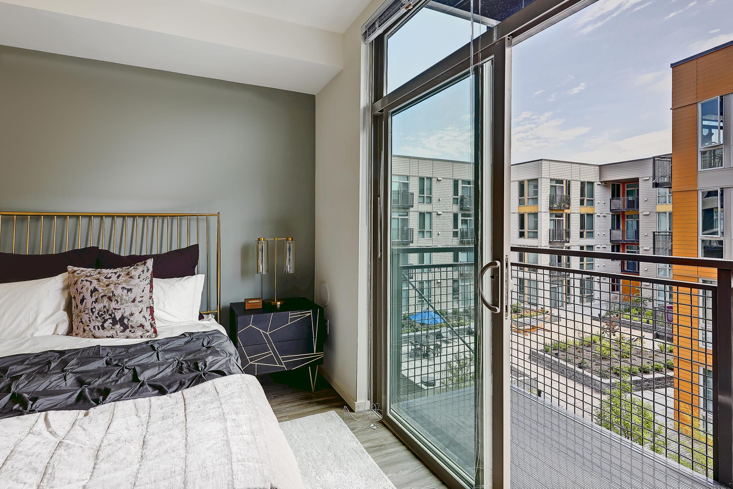A modern bedroom featuring a bed with decorative pillows and a stylish headboard.