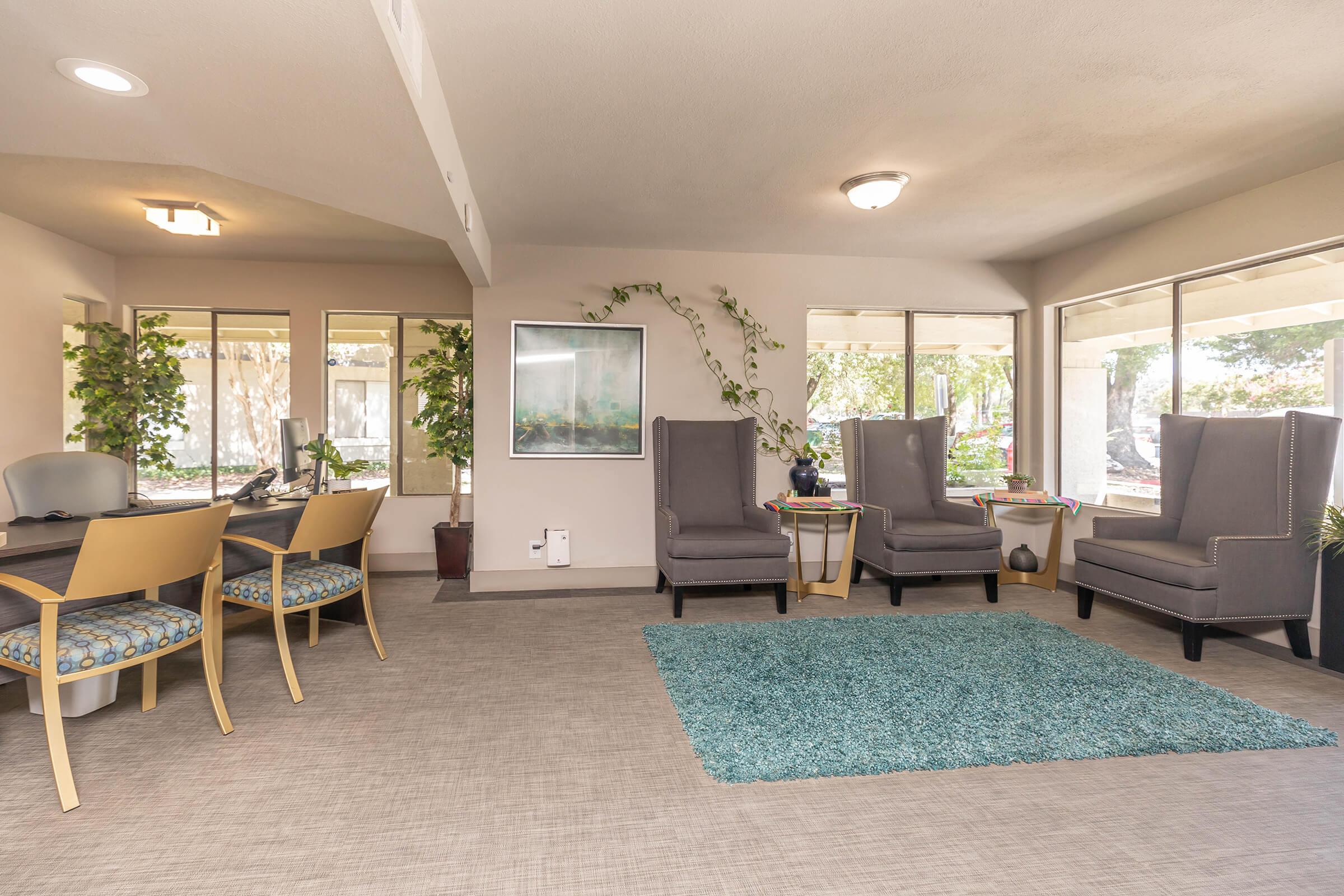 a living room filled with furniture and a large window